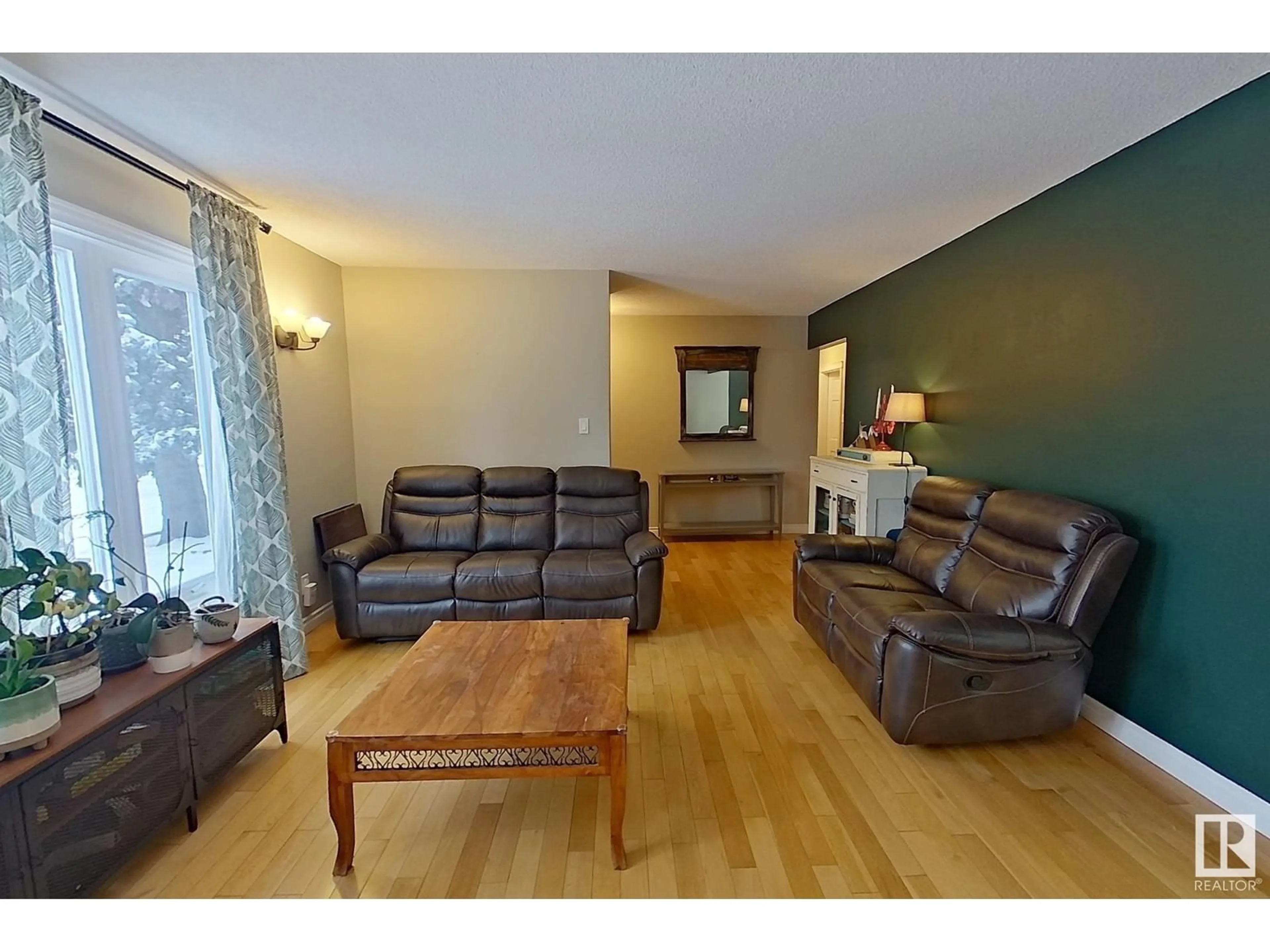 Living room with furniture, wood/laminate floor for 10512 104 ST, Westlock Alberta T7P1M1