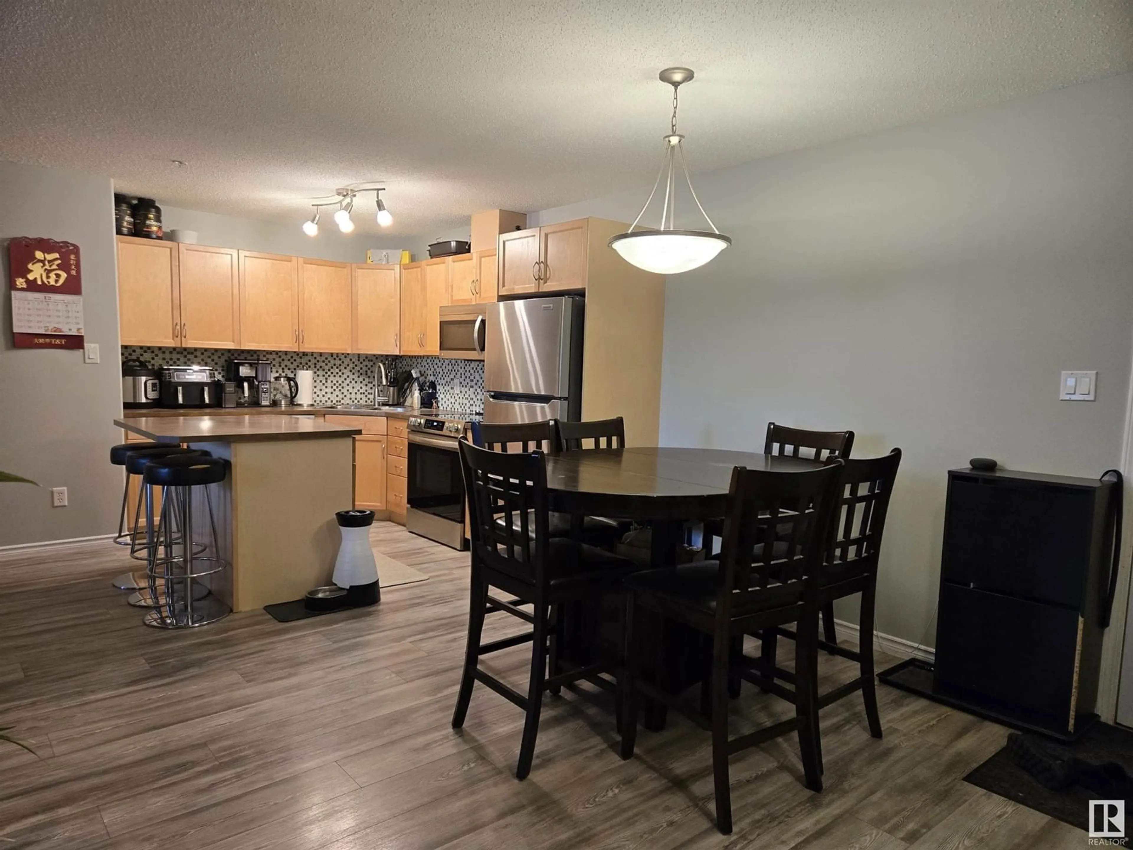 Open concept kitchen, wood/laminate floor for #107 2098 BLACKMUD CREEK DR SW, Edmonton Alberta T6W1T7