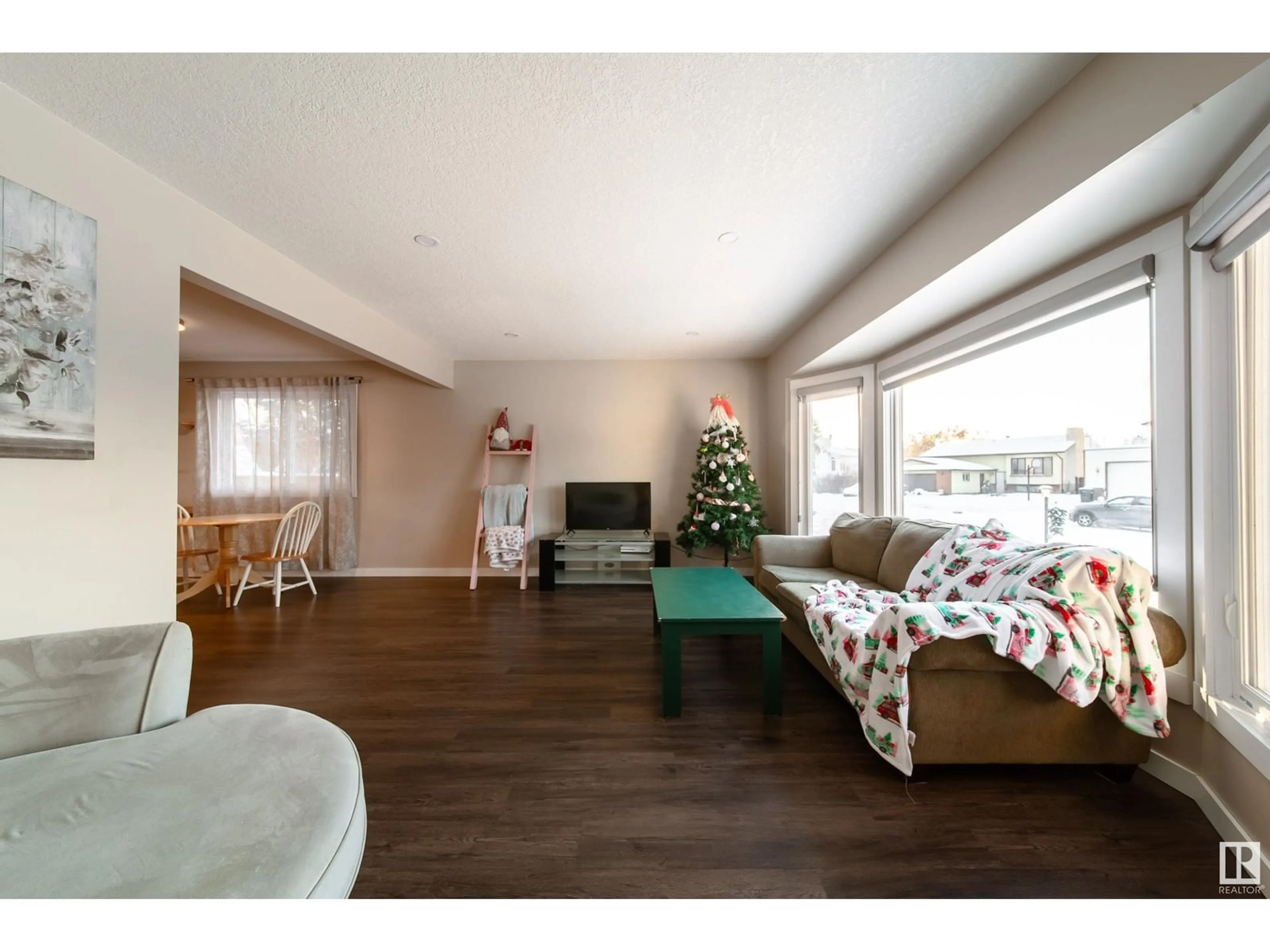 Living room with furniture, wood/laminate floor for 6416 17 AV NW, Edmonton Alberta T6L1N4