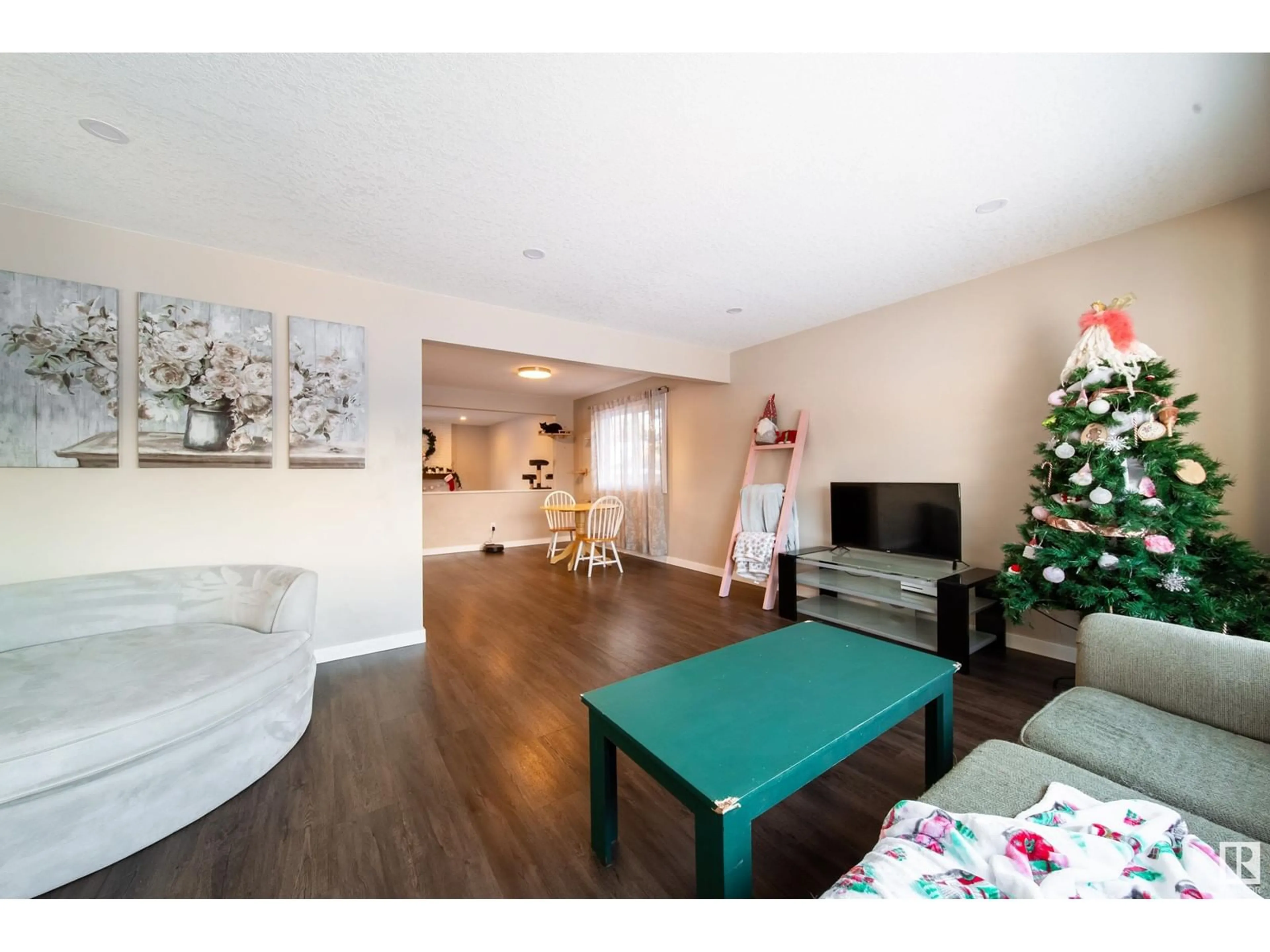 Living room with furniture, wood/laminate floor for 6416 17 AV NW, Edmonton Alberta T6L1N4