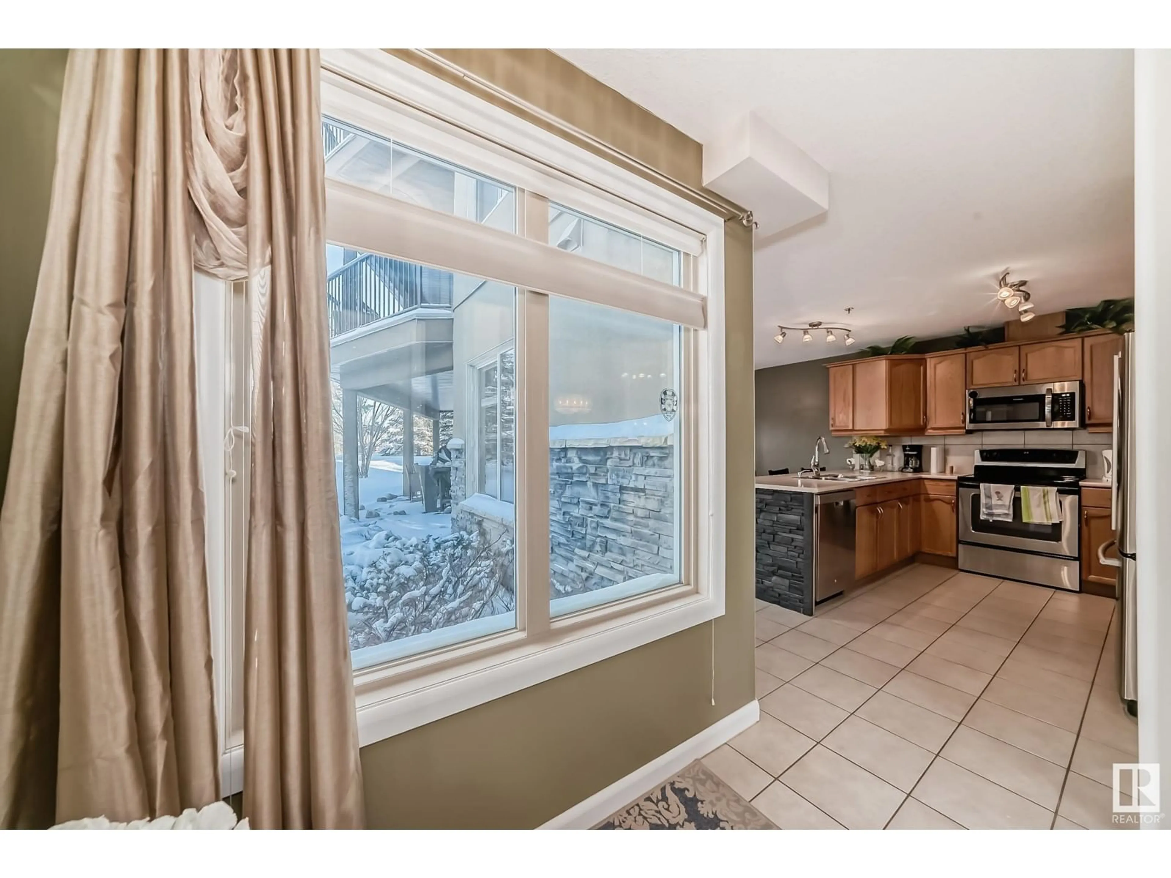 Open concept kitchen, ceramic/tile floor for #111 530 HOOKE RD NW, Edmonton Alberta T5A5J5