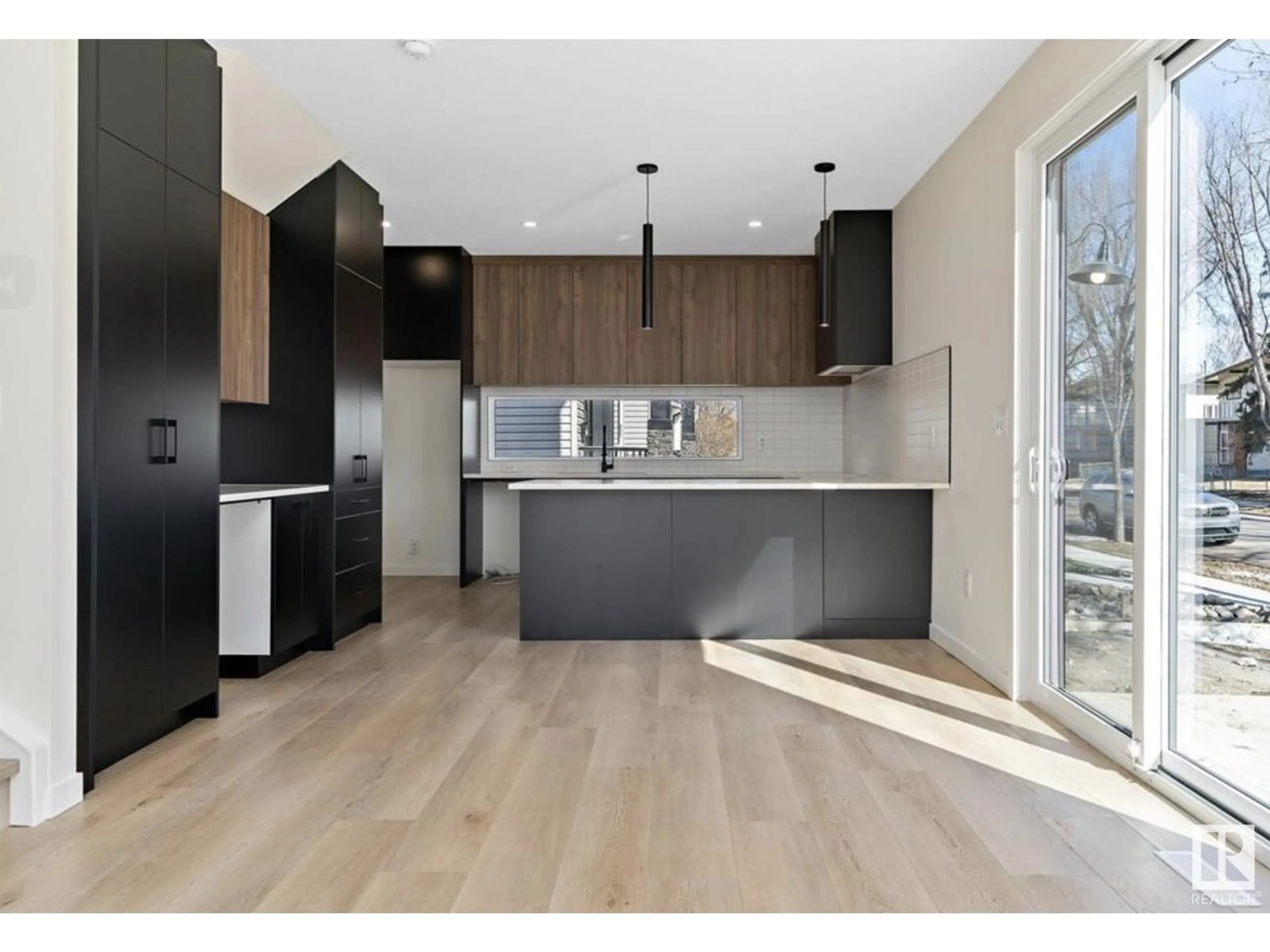 Open concept kitchen, wood/laminate floor for 8402 87 ST NW, Edmonton Alberta T6C1E2