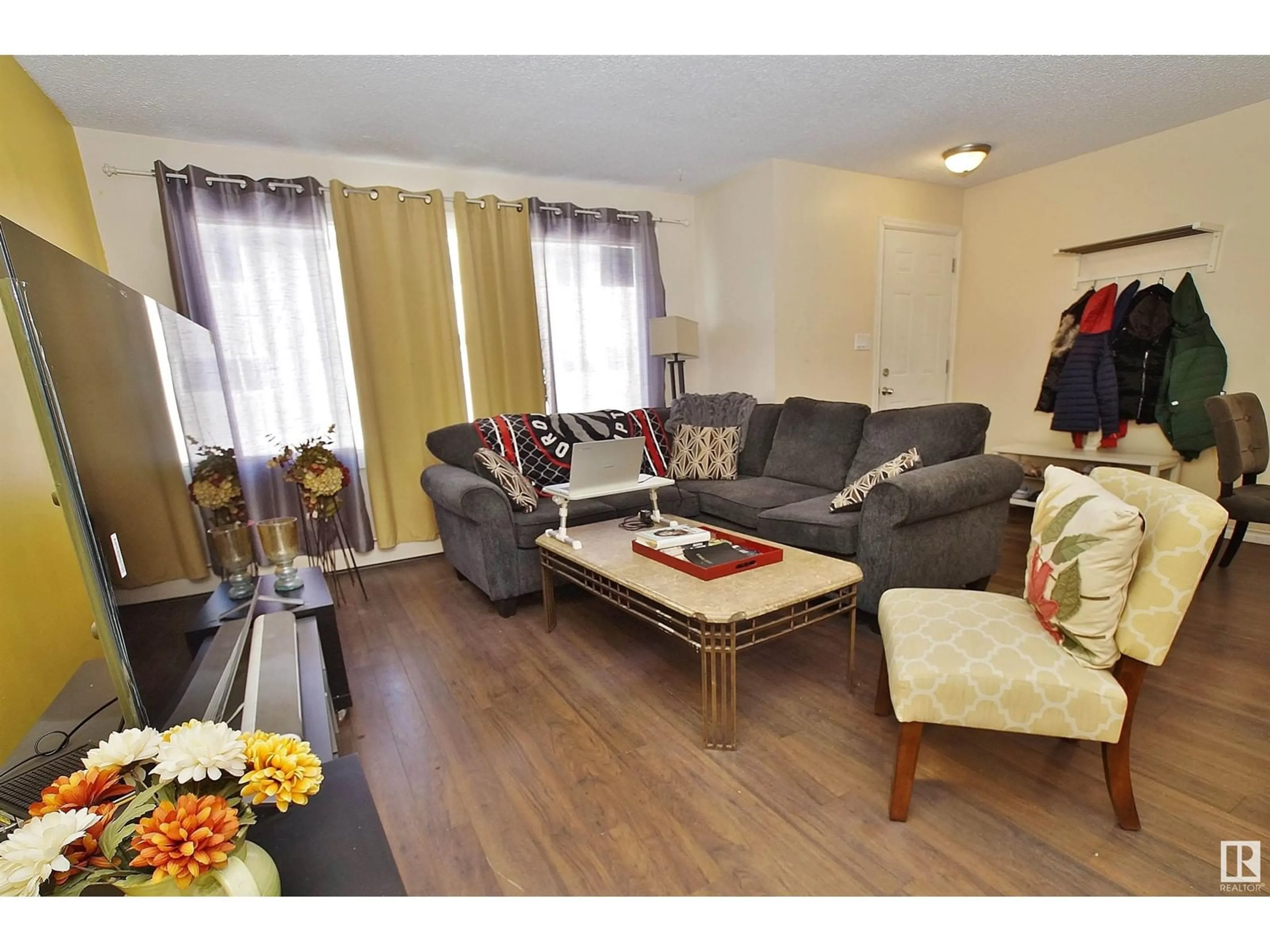 Living room with furniture, wood/laminate floor for #10 13570 38 ST NW, Edmonton Alberta T5A2W7