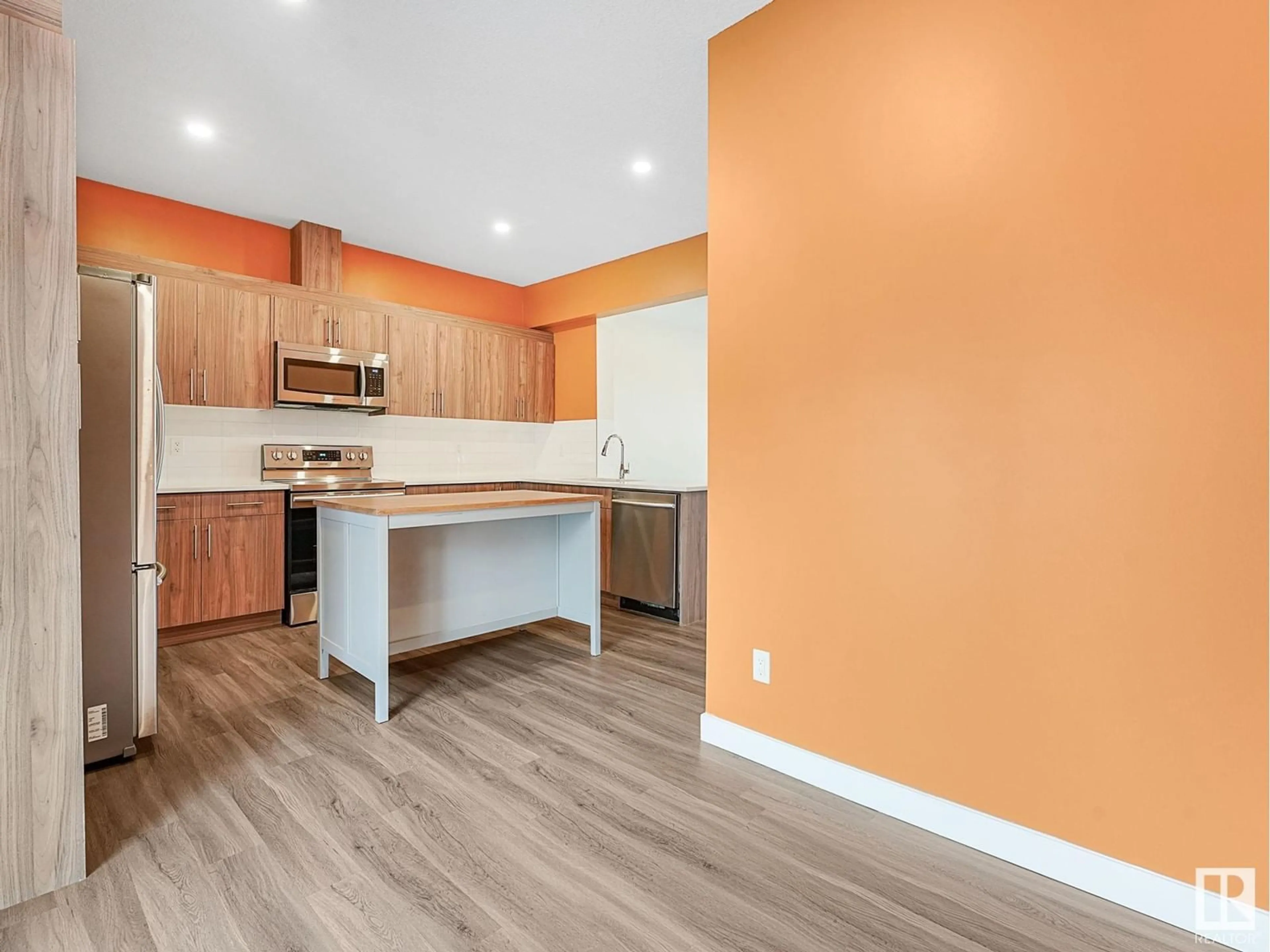 Open concept kitchen, wood/laminate floor for #57 1051 GRAYDON HILL BV SW, Edmonton Alberta T6W1A3