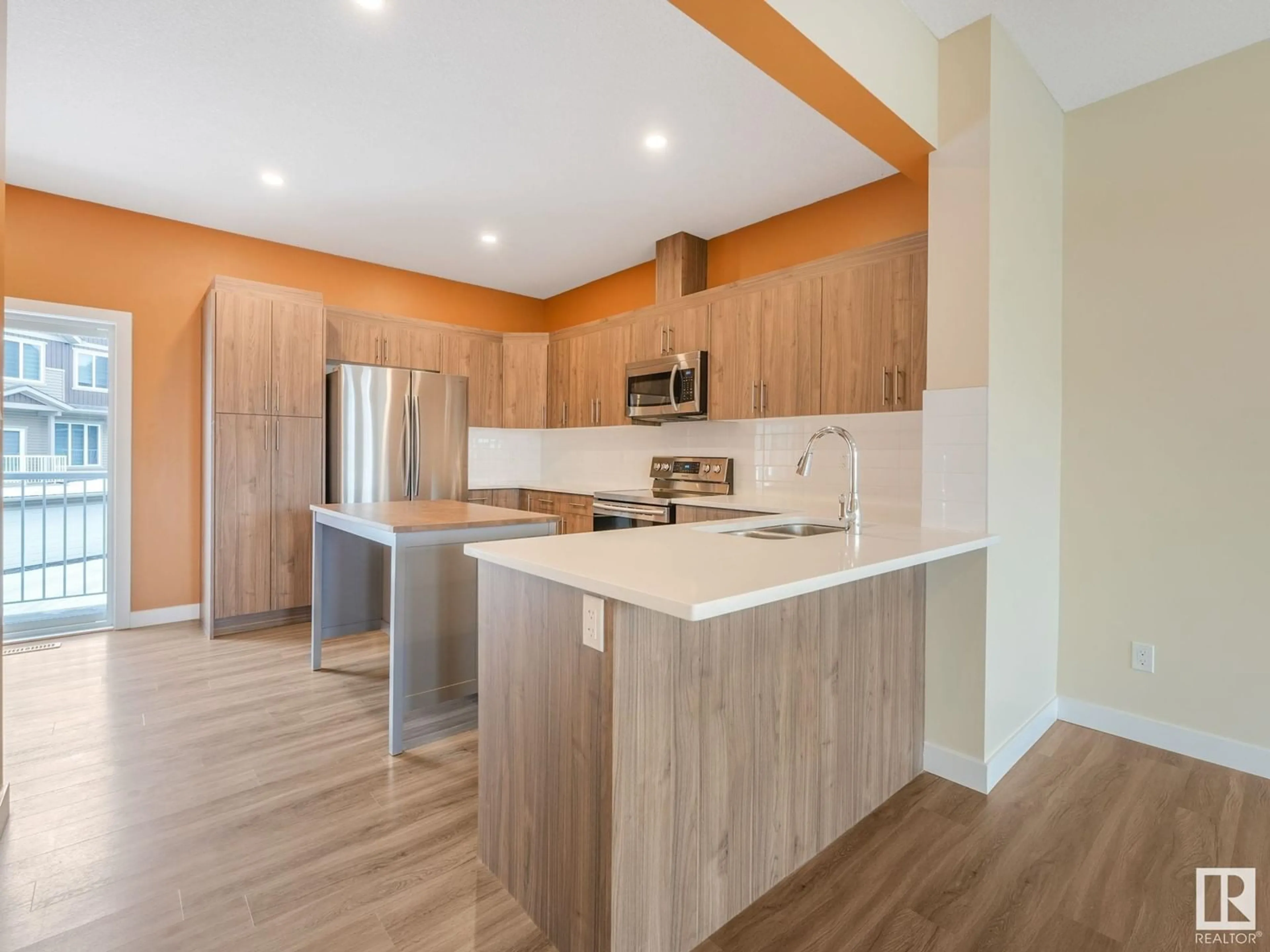 Open concept kitchen, wood/laminate floor for #57 1051 GRAYDON HILL BV SW, Edmonton Alberta T6W1A3