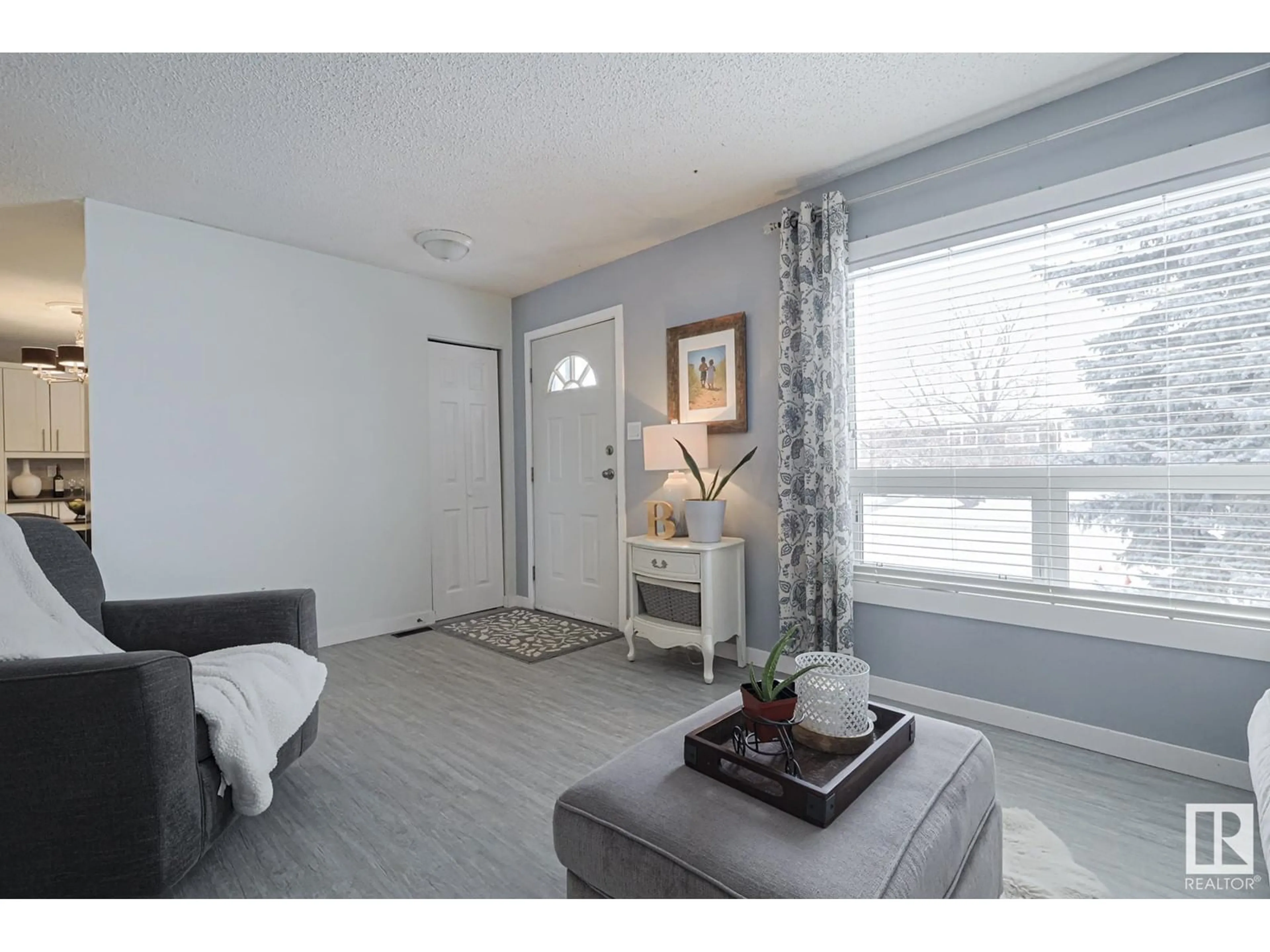 Living room with furniture, wood/laminate floor for 4407 51 ST, Beaumont Alberta T4X1C7