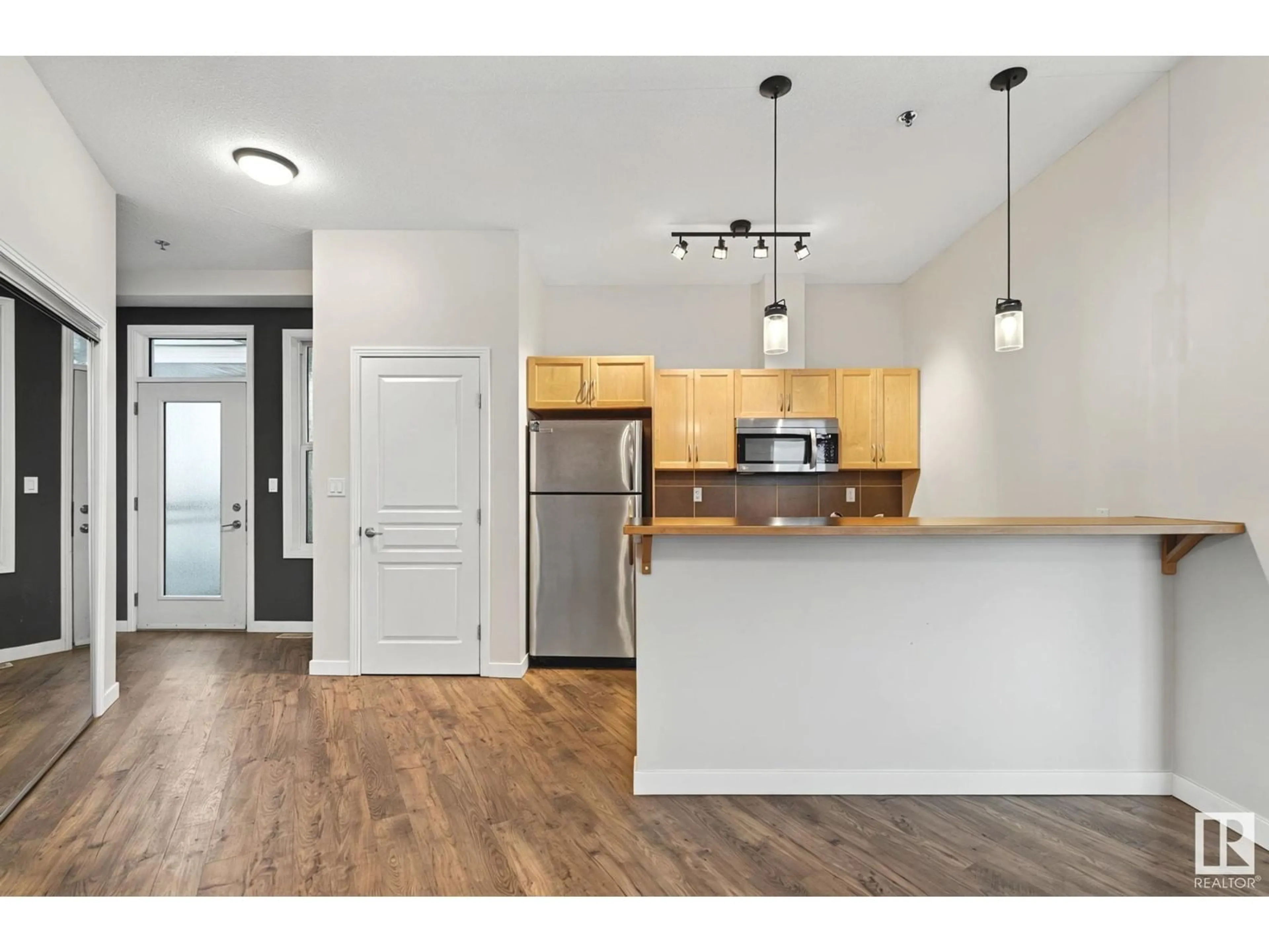 Open concept kitchen, wood/laminate floor for #442 4827 104A ST NW, Edmonton Alberta T6H0R5