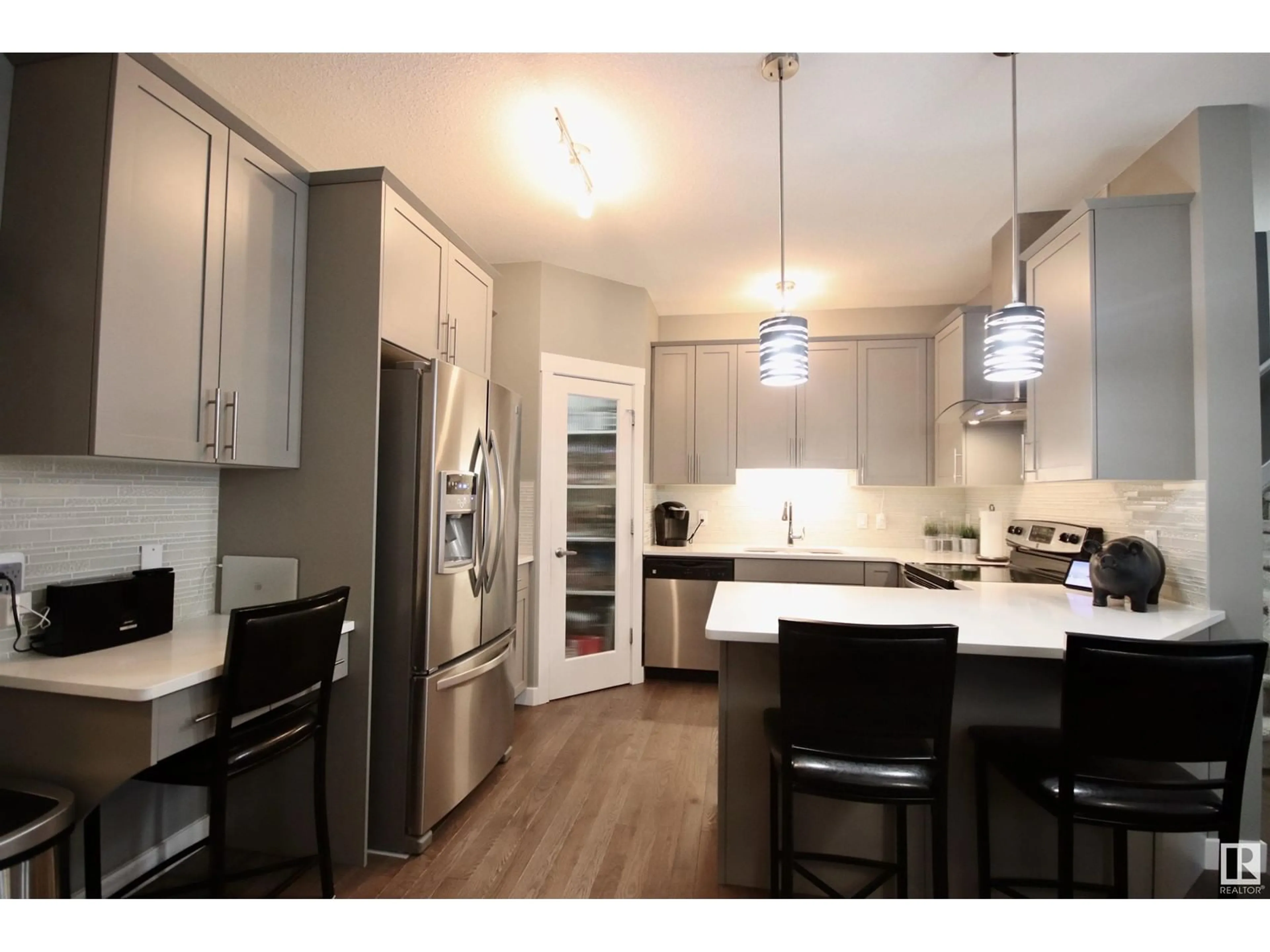 Open concept kitchen, wood/laminate floor for 20728 99 AV NW, Edmonton Alberta T5T7G3