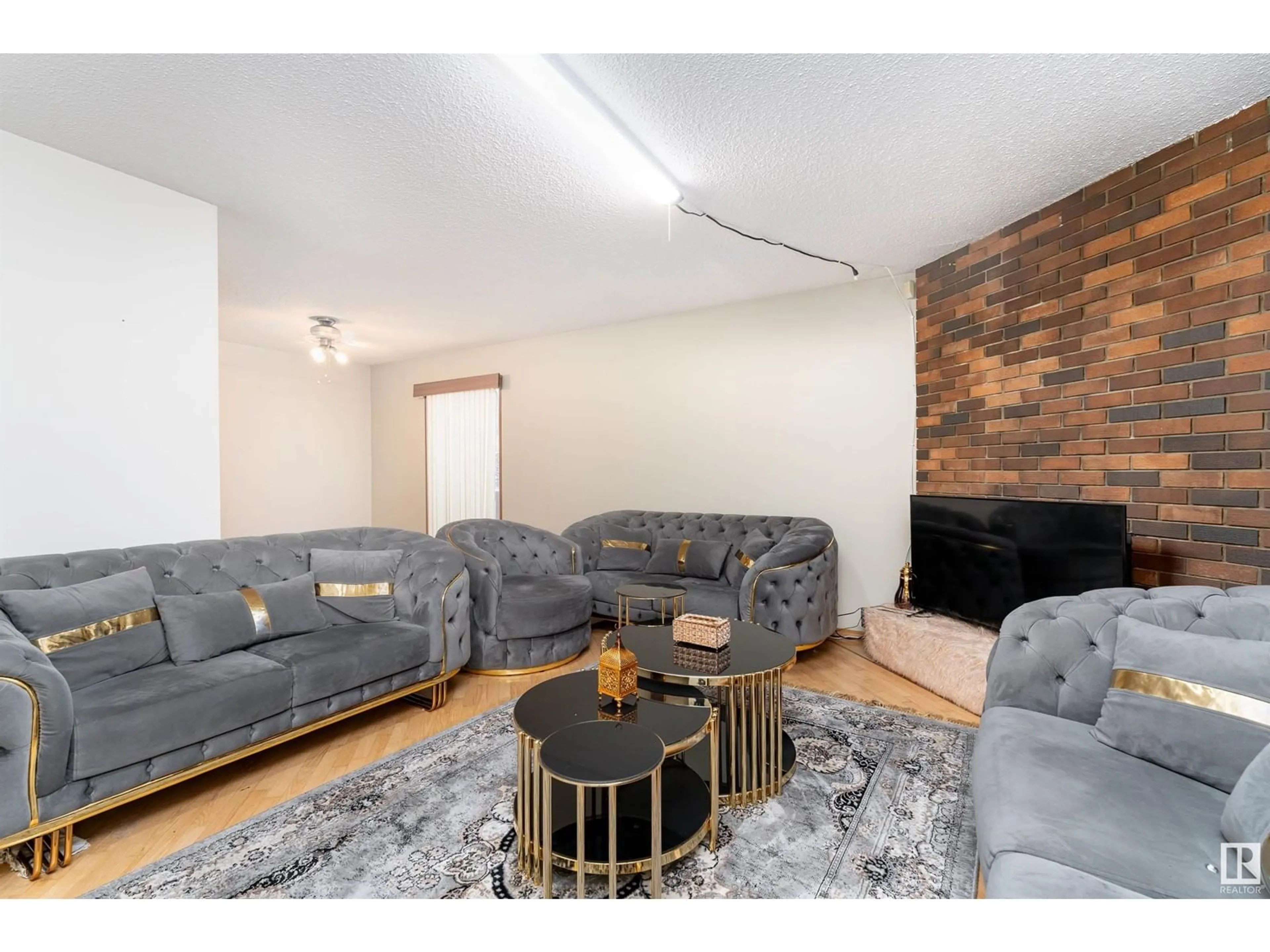 Living room with furniture, wood/laminate floor for 14511 117 ST NW, Edmonton Alberta T5X1J9