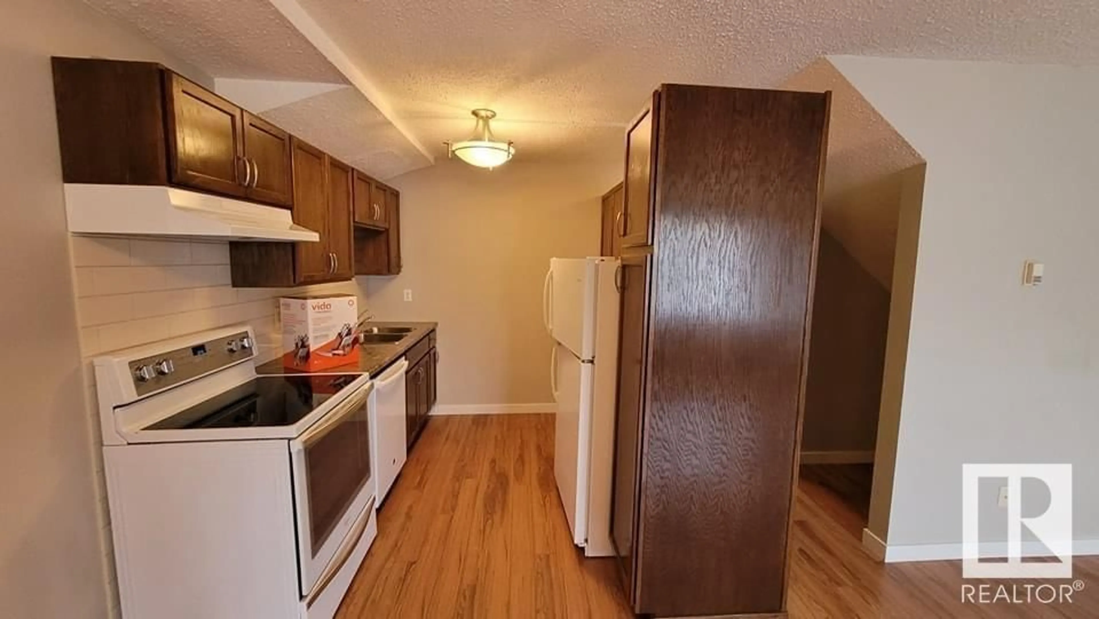 Standard kitchen, wood/laminate floor for #49 13590 38 Street NW NW, Edmonton Alberta T5A2W7