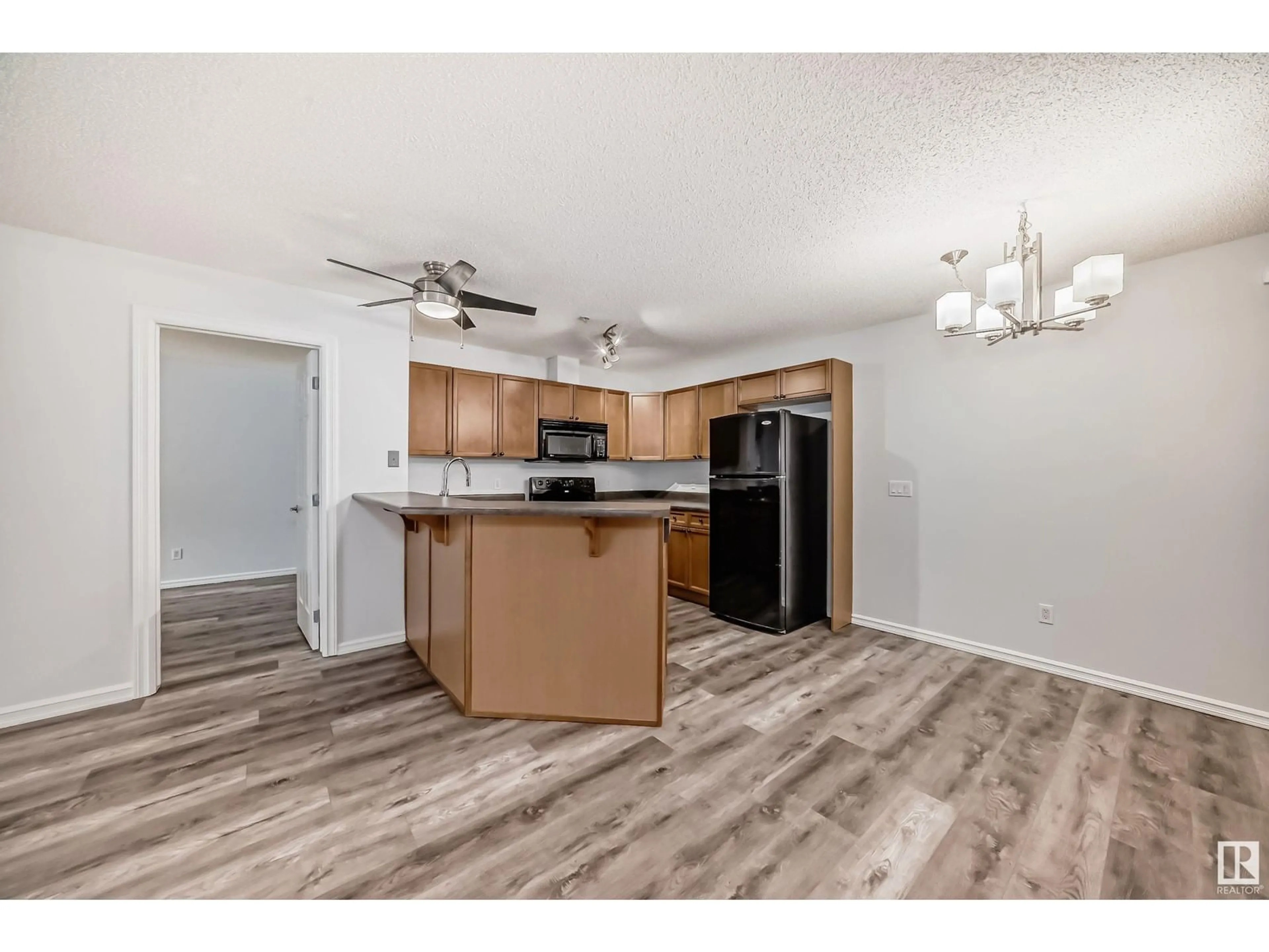 Open concept kitchen, wood/laminate floor for #110 - 13710 150 AV, Edmonton Alberta T6V0B2