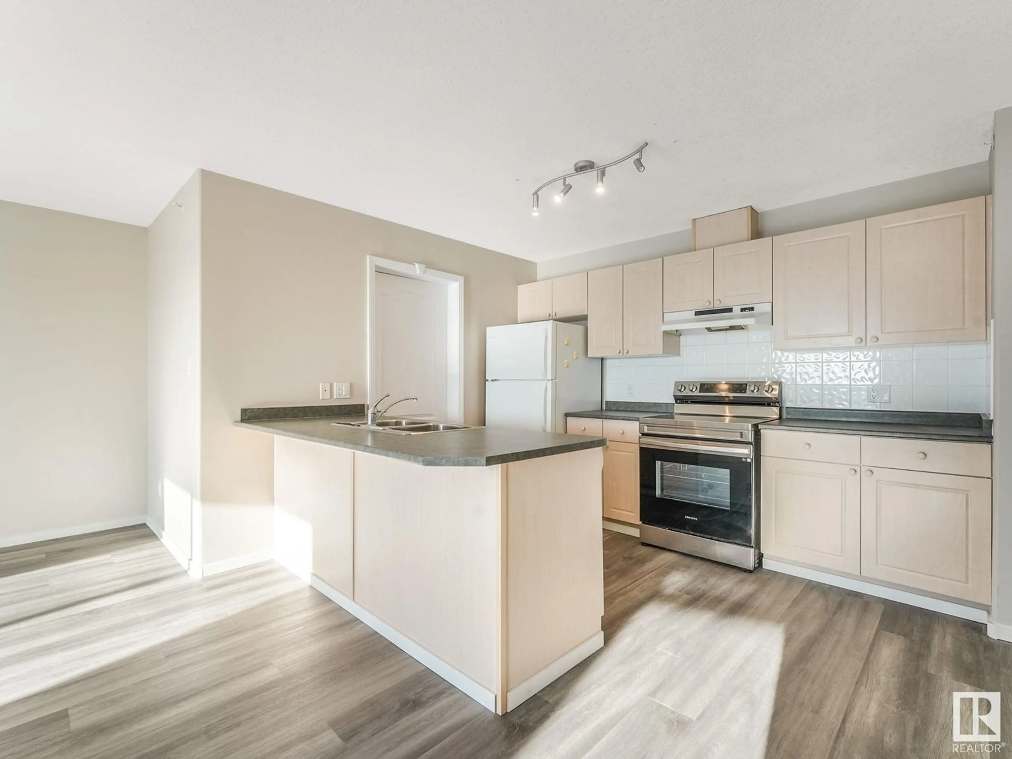 Open concept kitchen, wood/laminate floor for #409 592 HOOKE RD NW NW, Edmonton Alberta T5A5H2