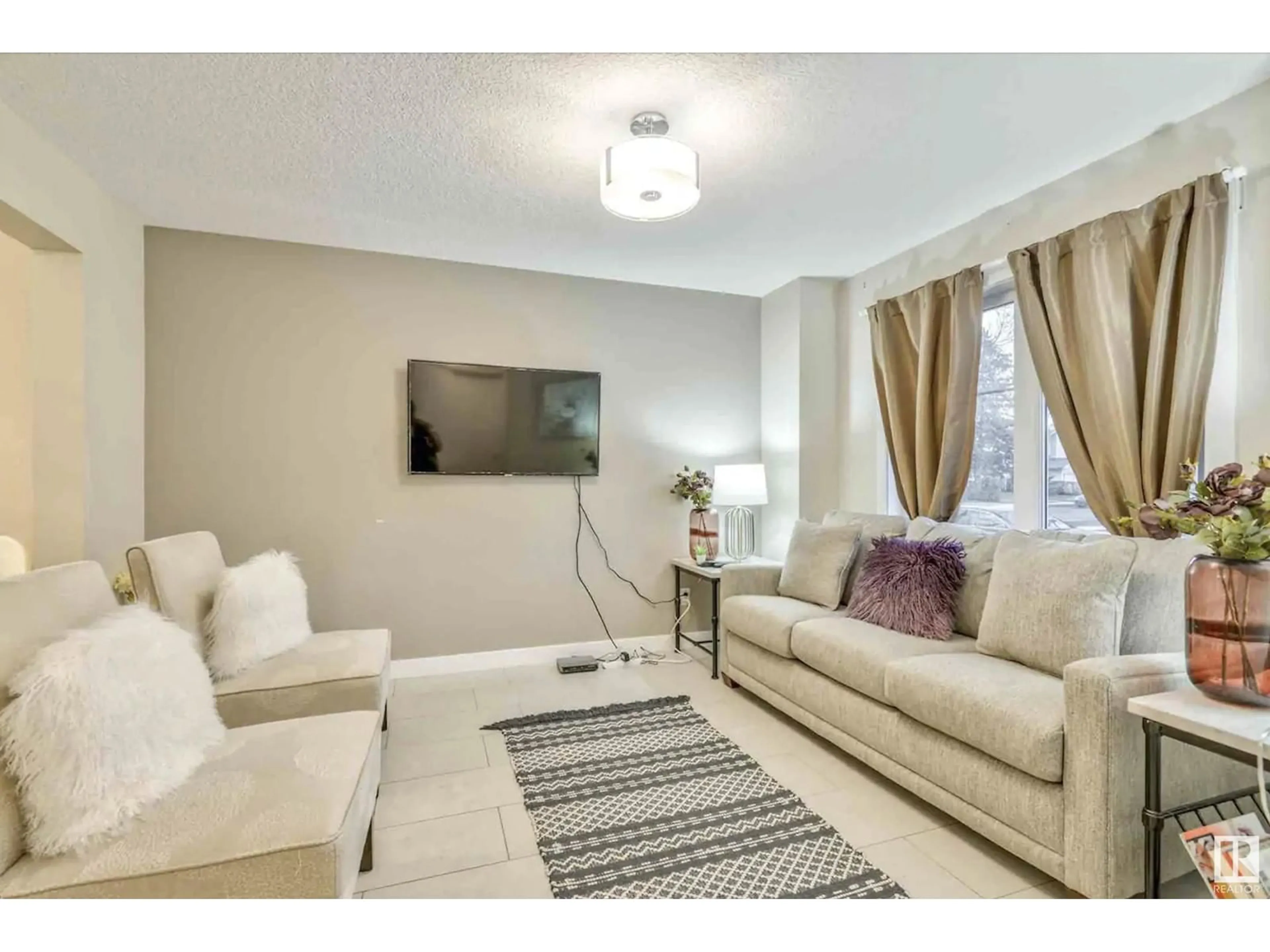 Living room with furniture, carpet floor for 12219 117 AV NW, Edmonton Alberta T5M0G7