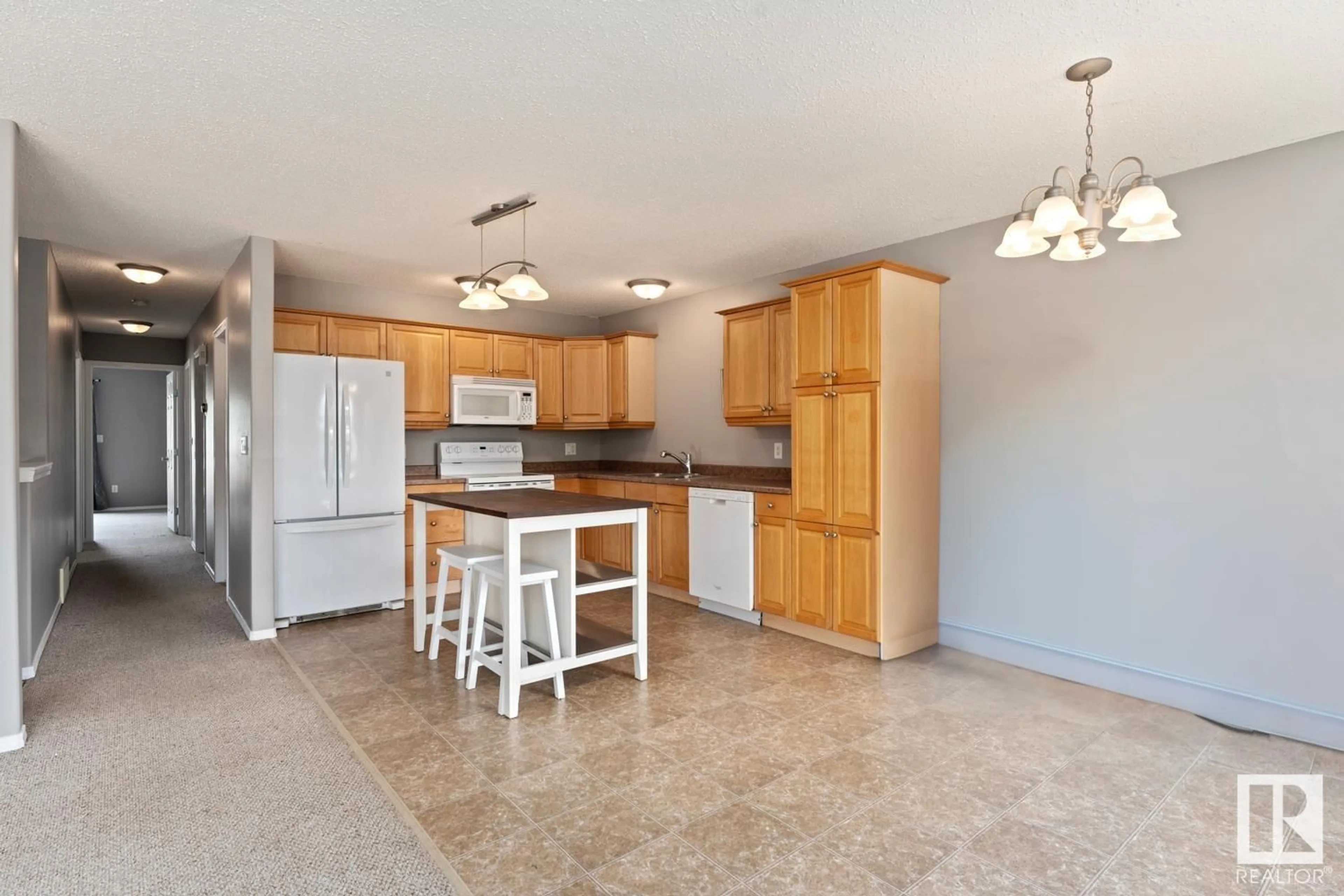 Open concept kitchen, ceramic/tile floor for #102 4103 43 AV, Bonnyville Town Alberta T9N1W4