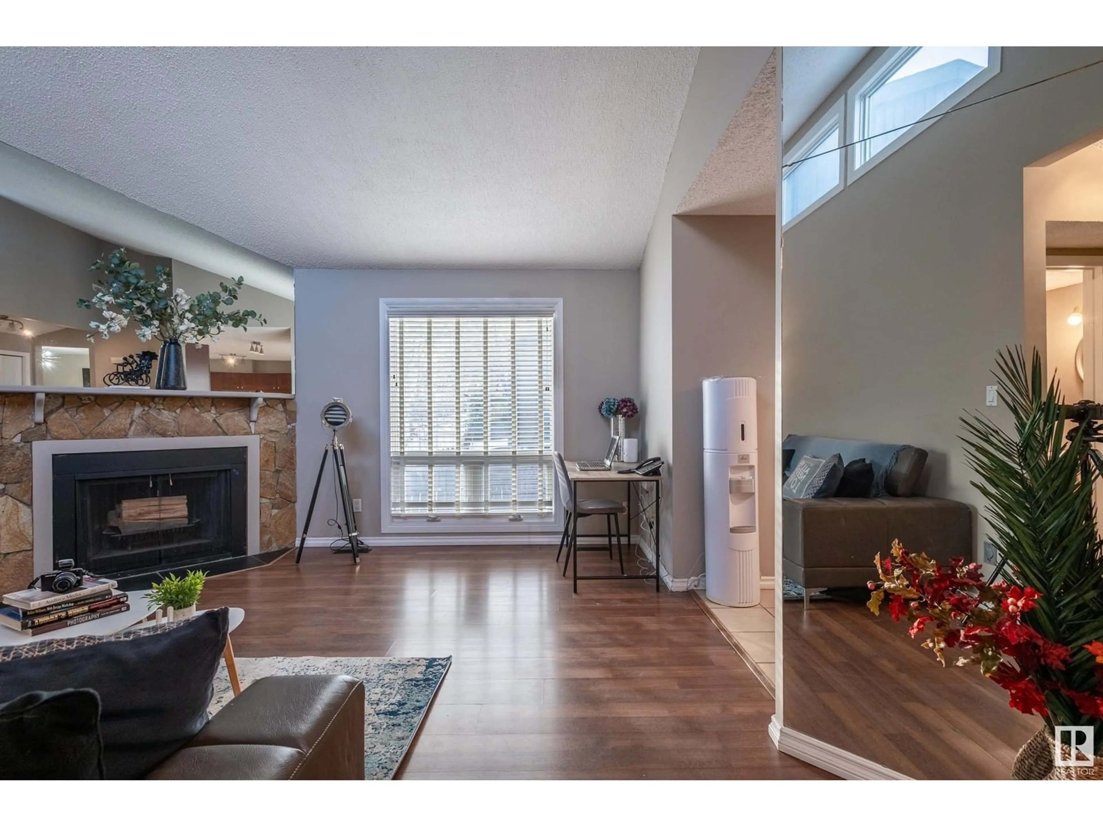 Living room with furniture, wood/laminate floor for 14167 26 ST NW, Edmonton Alberta T5Y1S2