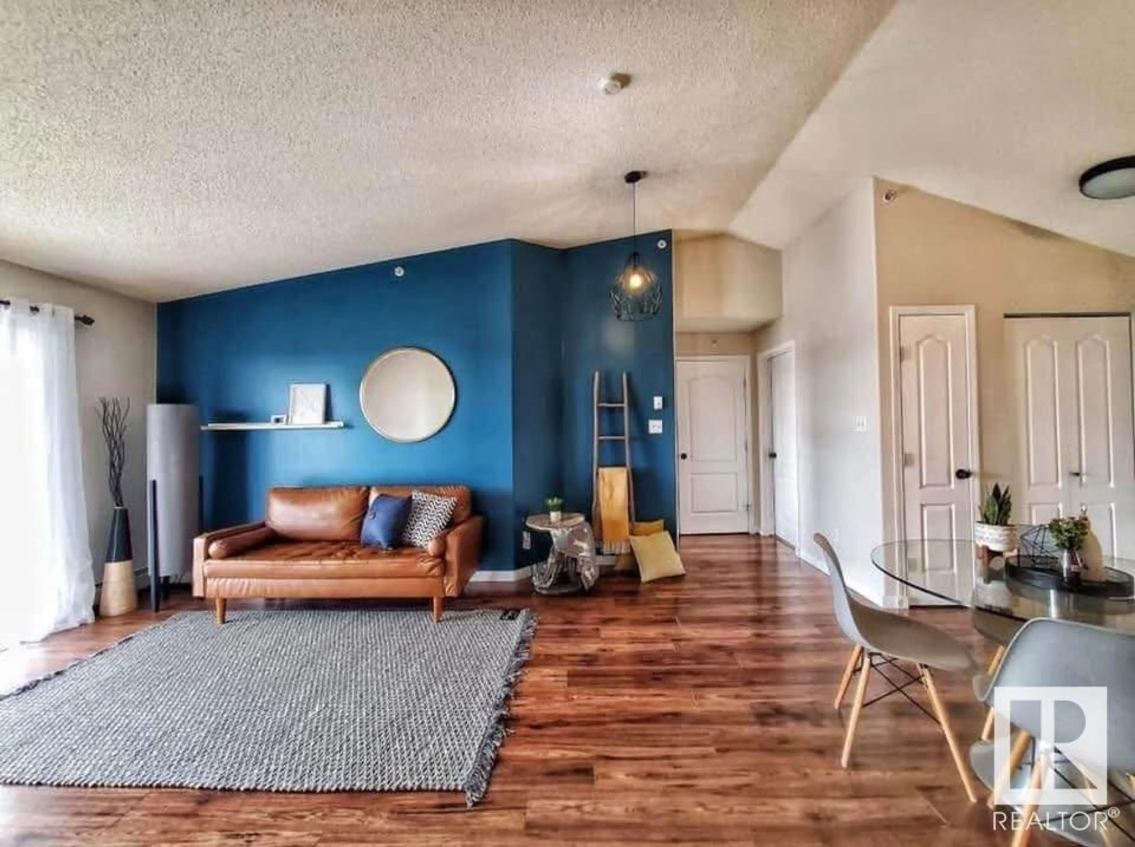 Living room with furniture, wood/laminate floor for #439 3425 19 ST NW, Edmonton Alberta T6T2B5