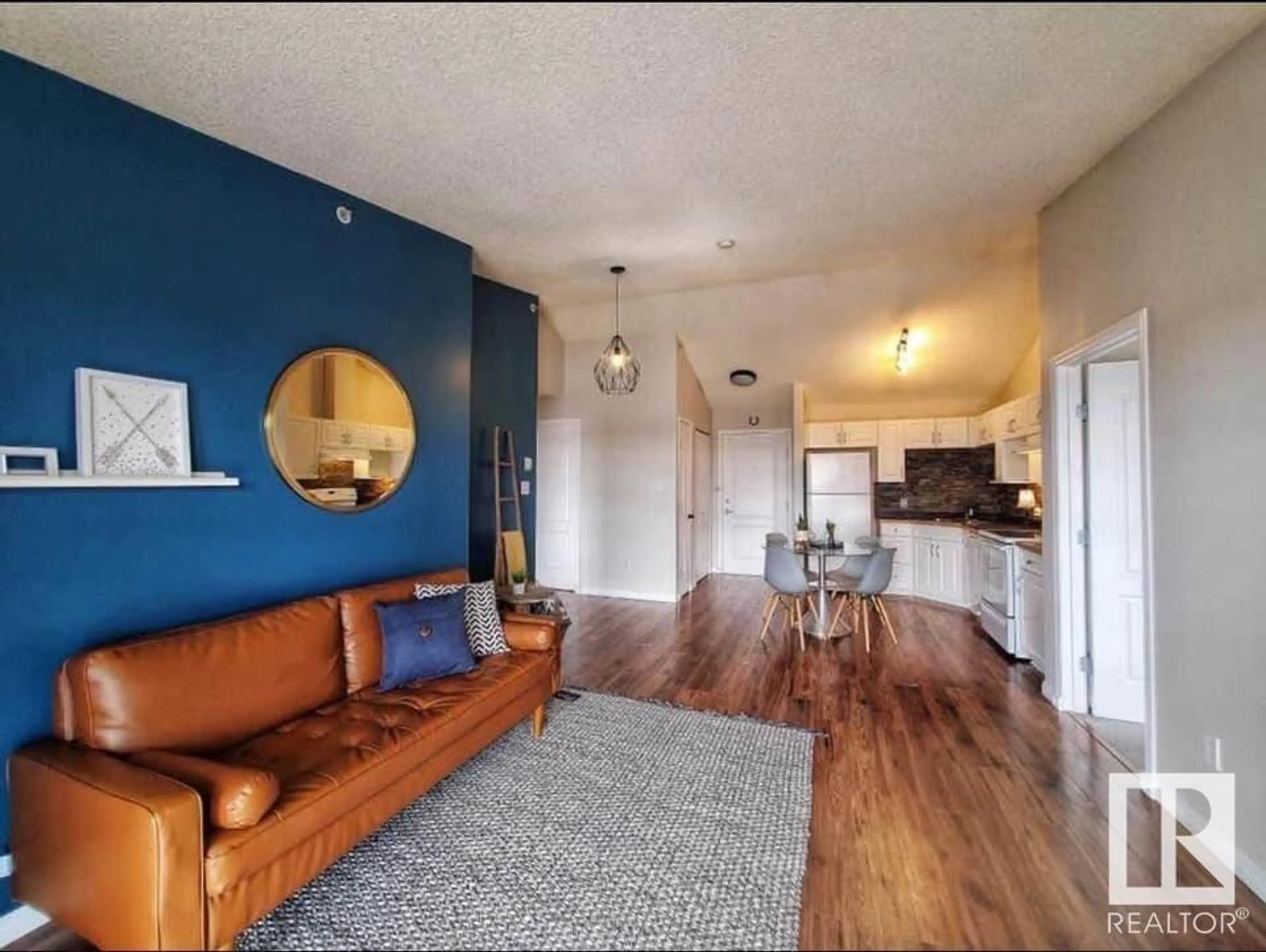 Living room with furniture, wood/laminate floor for #439 3425 19 ST NW, Edmonton Alberta T6T2B5