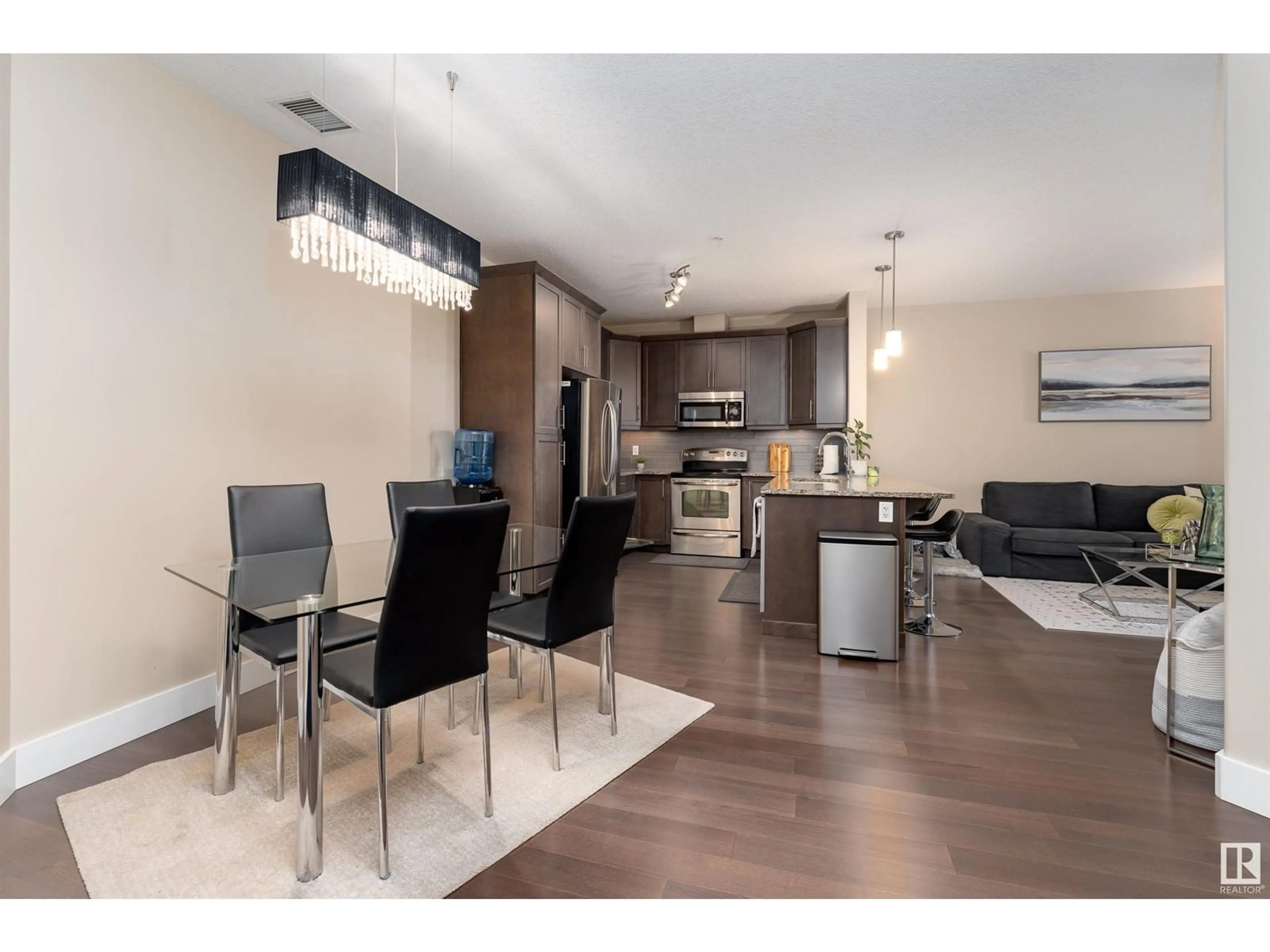 Open concept kitchen, wood/laminate floor for #347 6079 MAYNARD WY NW, Edmonton Alberta T6R0S4