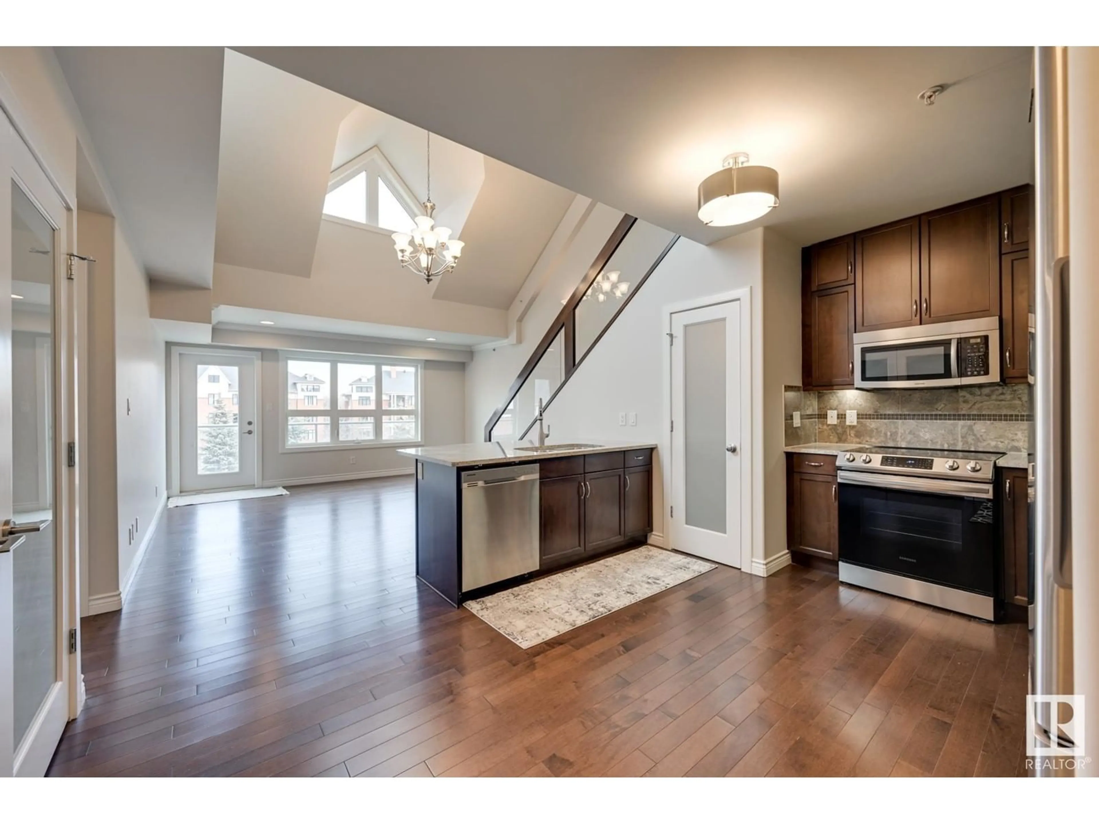 Open concept kitchen, wood/laminate floor for #309 9603 98 AV NW, Edmonton Alberta T6C2E2