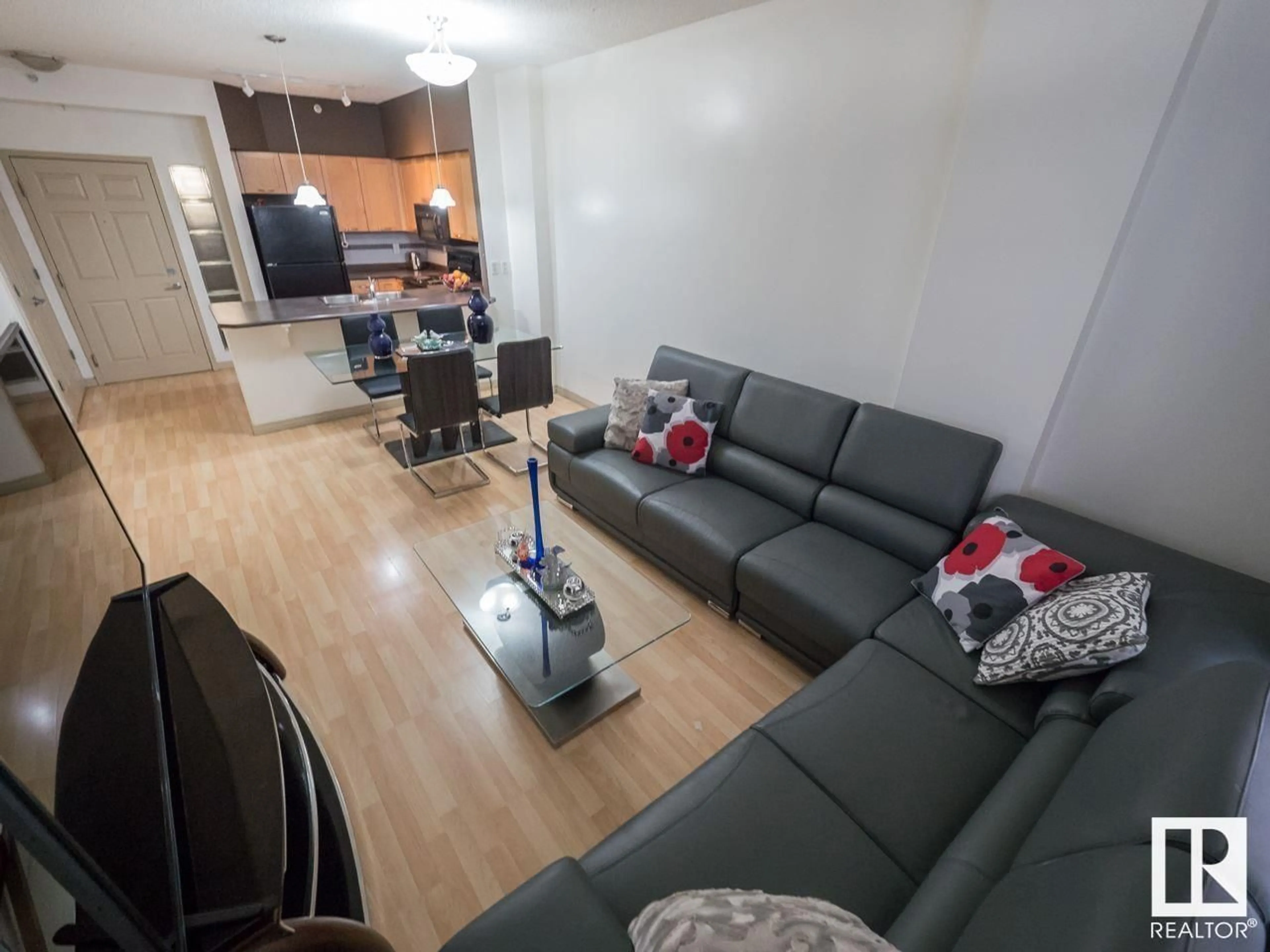 Living room with furniture, wood/laminate floor for #2-116 4245 139 AV NW, Edmonton Alberta T5Y3E8