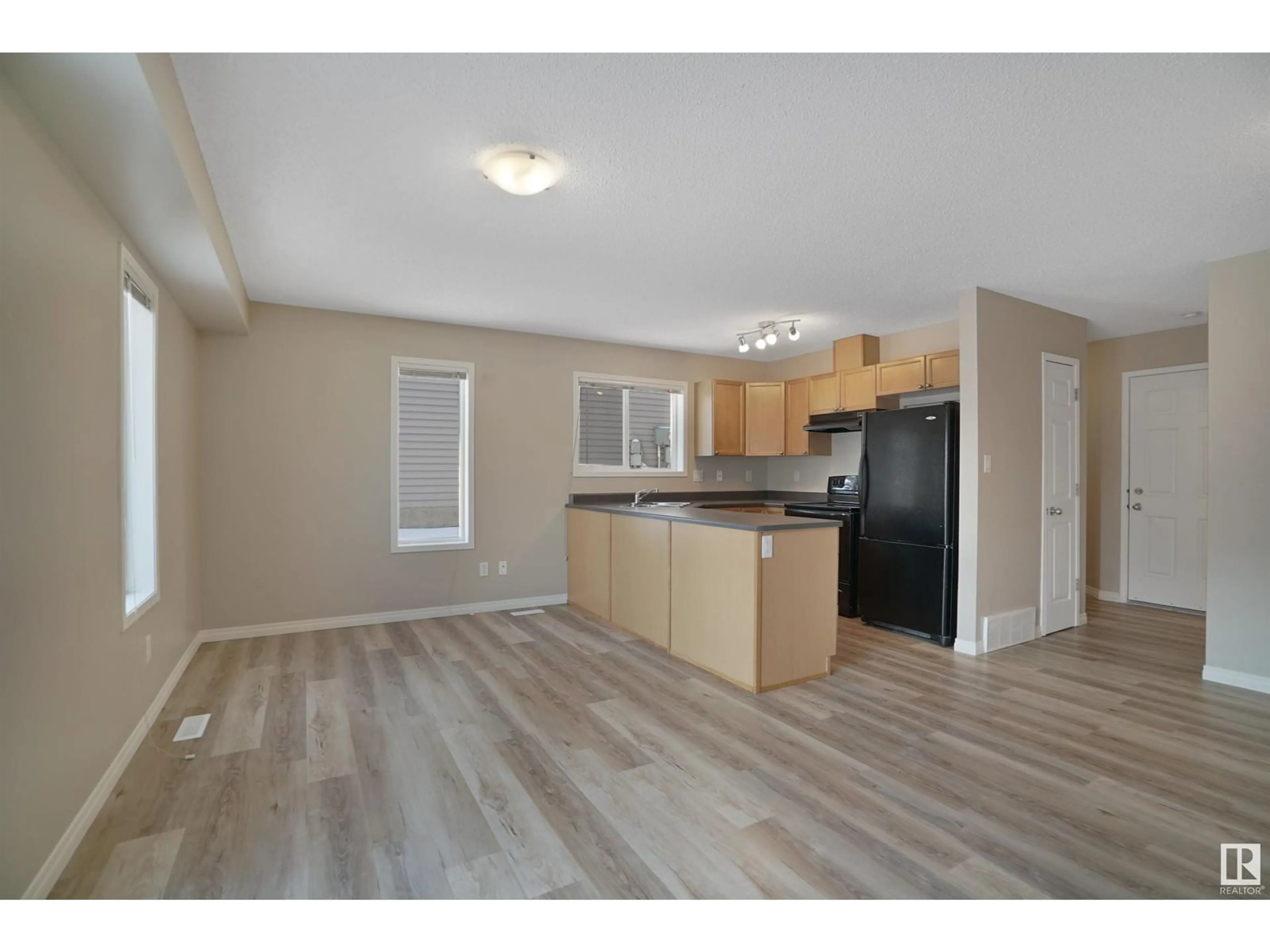 Open concept kitchen, wood/laminate floor for #41 130 HYNDMAN CR NW, Edmonton Alberta T5A0E8