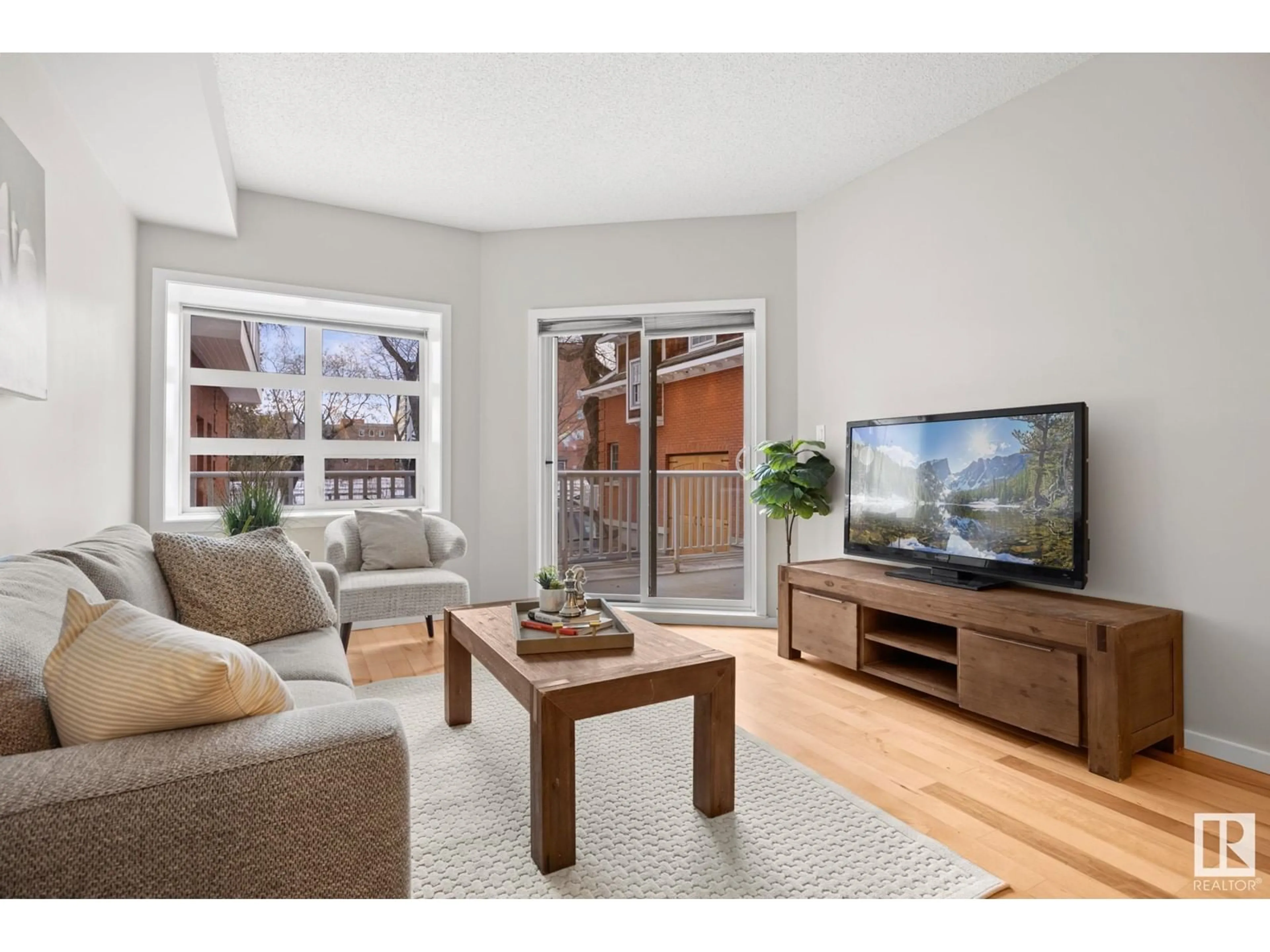 Living room with furniture, wood/laminate floor for #106 9910 111 ST NW NW, Edmonton Alberta T5K1K2