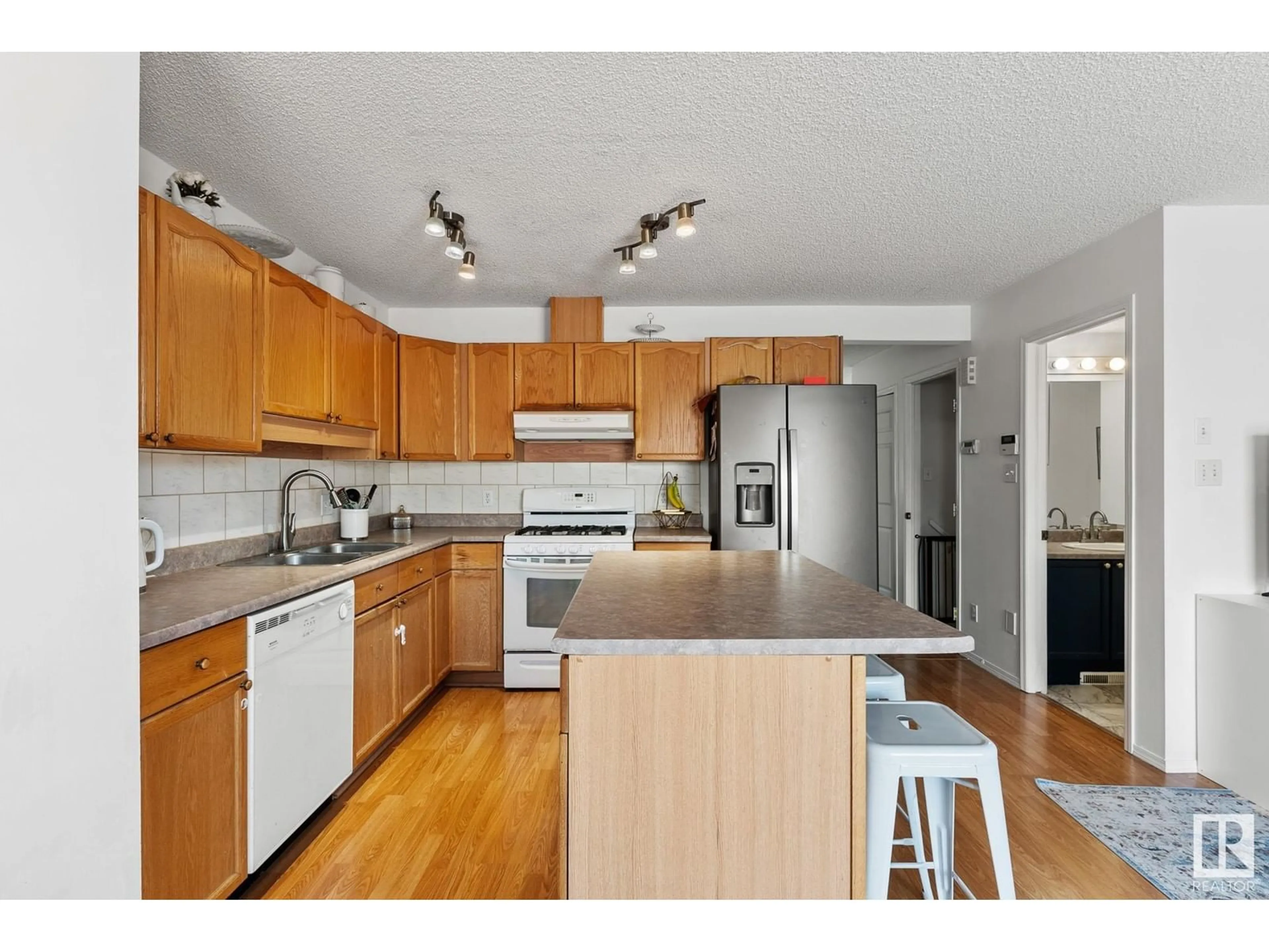 Open concept kitchen, wood/laminate floor for 16213 93 ST NW, Edmonton Alberta T5Z3M9