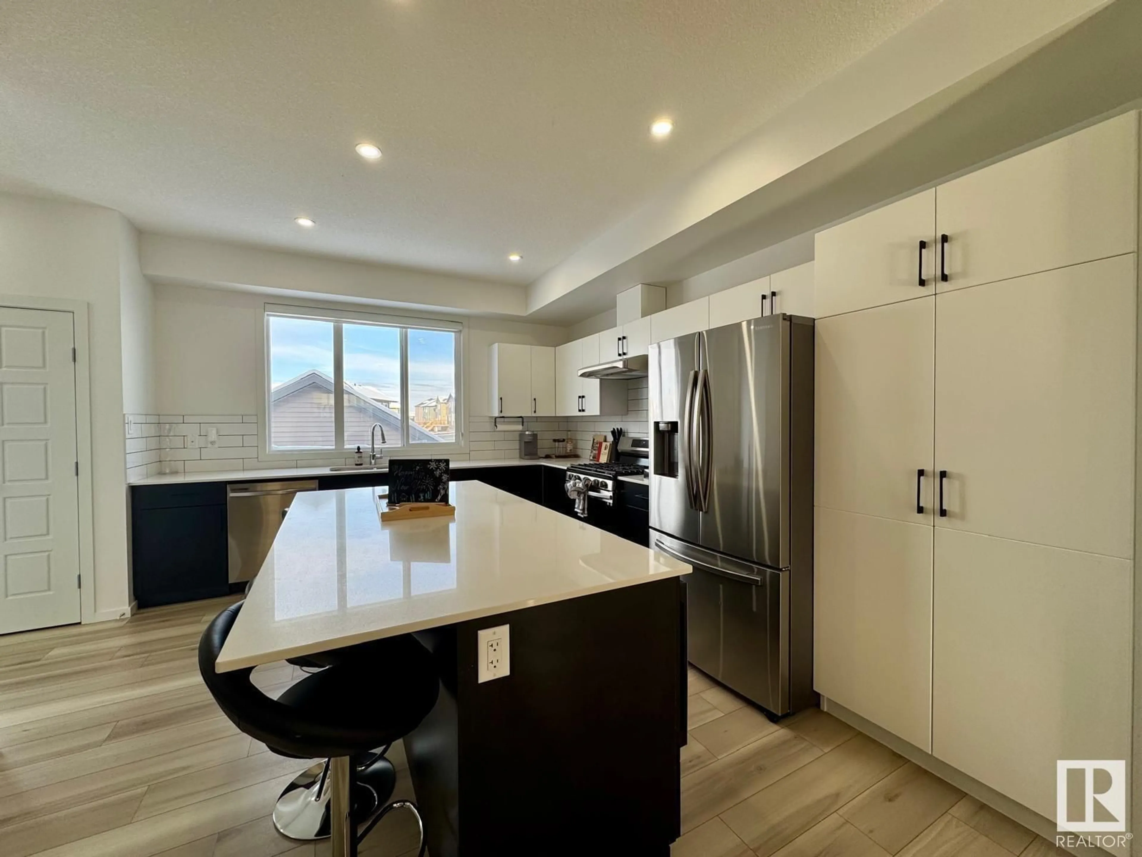 Open concept kitchen, wood/laminate floor for 5016 KINNEY LI, Edmonton Alberta T6W5G4