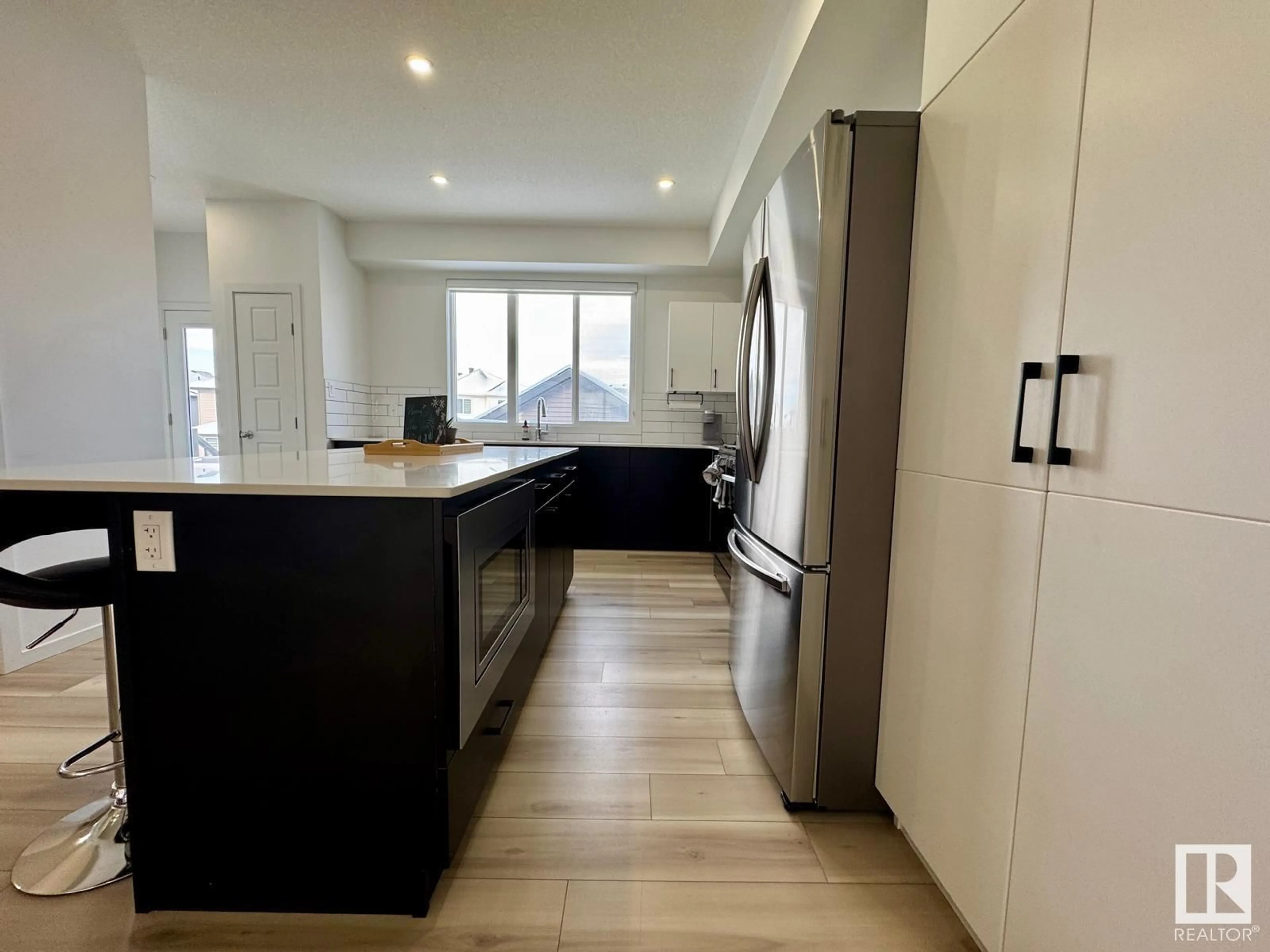 Open concept kitchen, wood/laminate floor for 5016 KINNEY LI, Edmonton Alberta T6W5G4