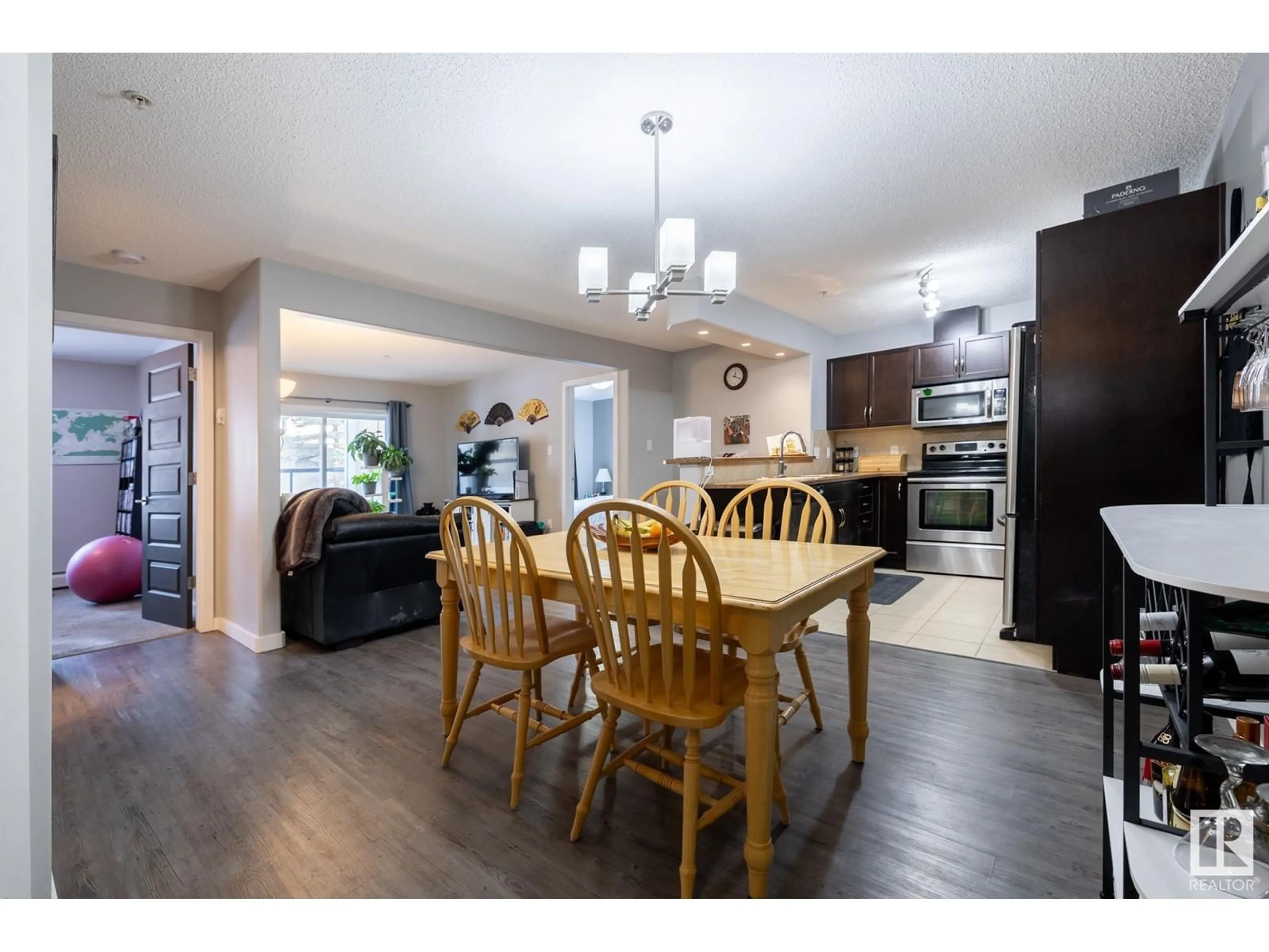 Open concept kitchen, wood/laminate floor for #129 11603 ELLERSLIE RD SW, Edmonton Alberta T6W0J3