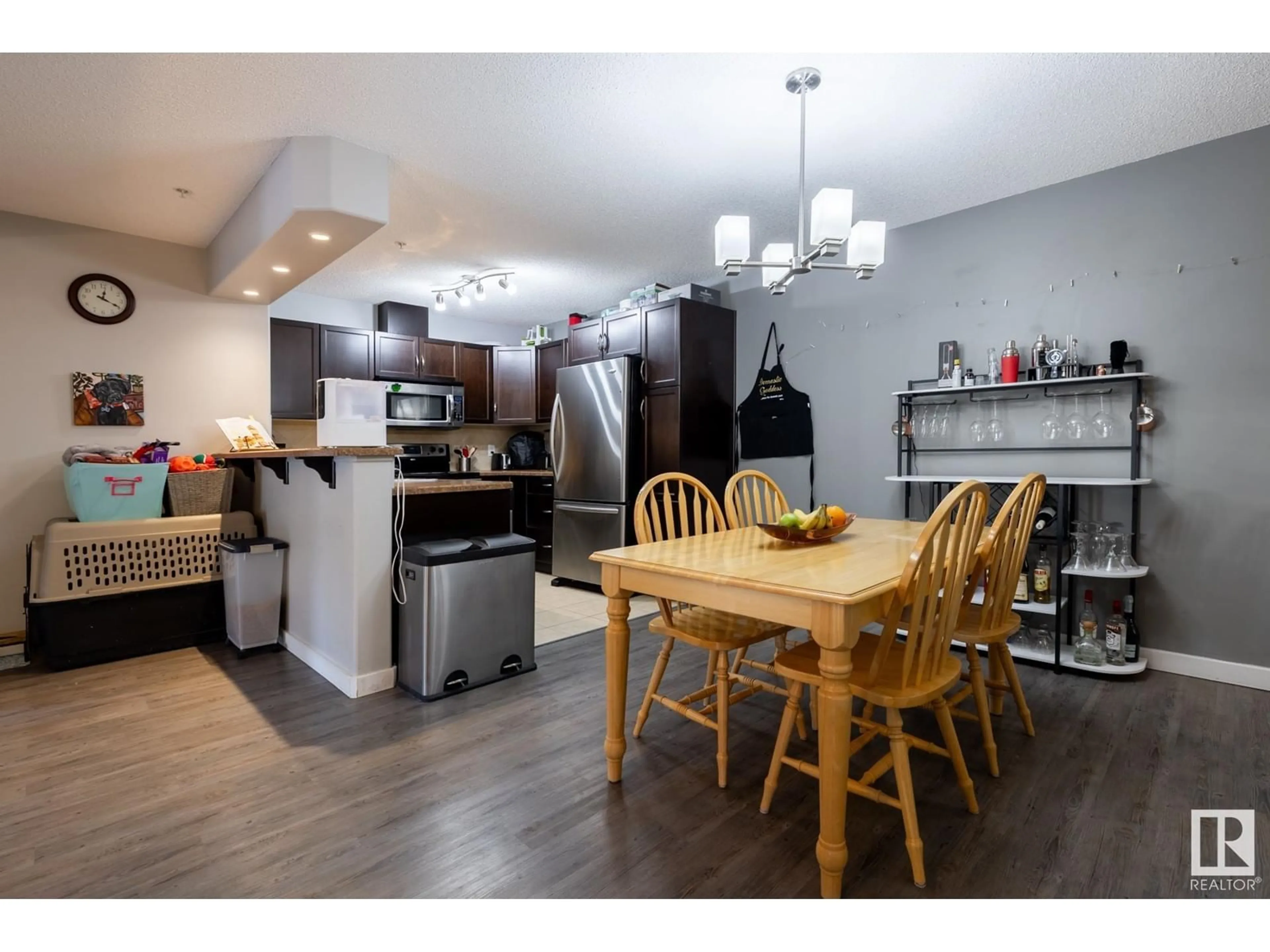 Open concept kitchen, wood/laminate floor for #129 11603 ELLERSLIE RD SW, Edmonton Alberta T6W0J3