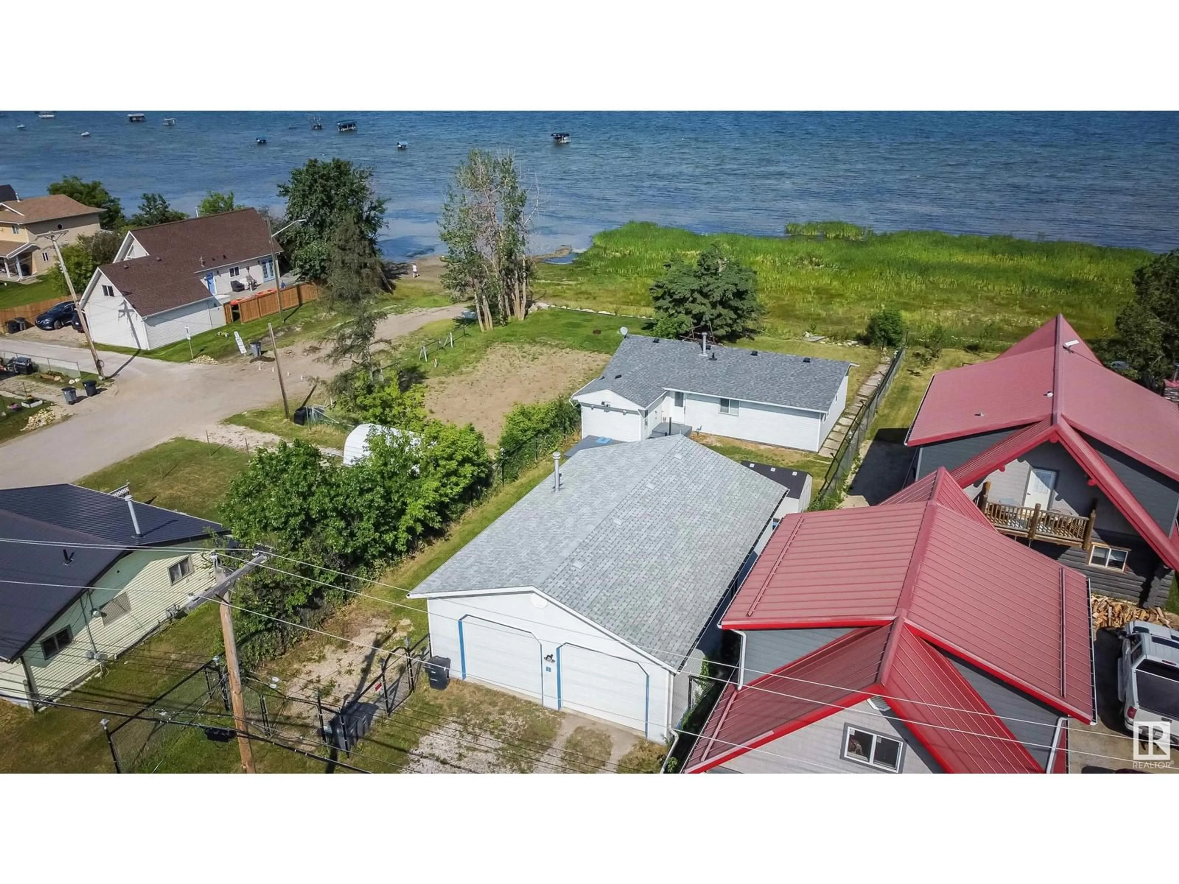 A pic from outside/outdoor area/front of a property/back of a property/a pic from drone, water/lake/river/ocean view for 5036 50 AV, Rural Lac Ste. Anne County Alberta T0E0A0