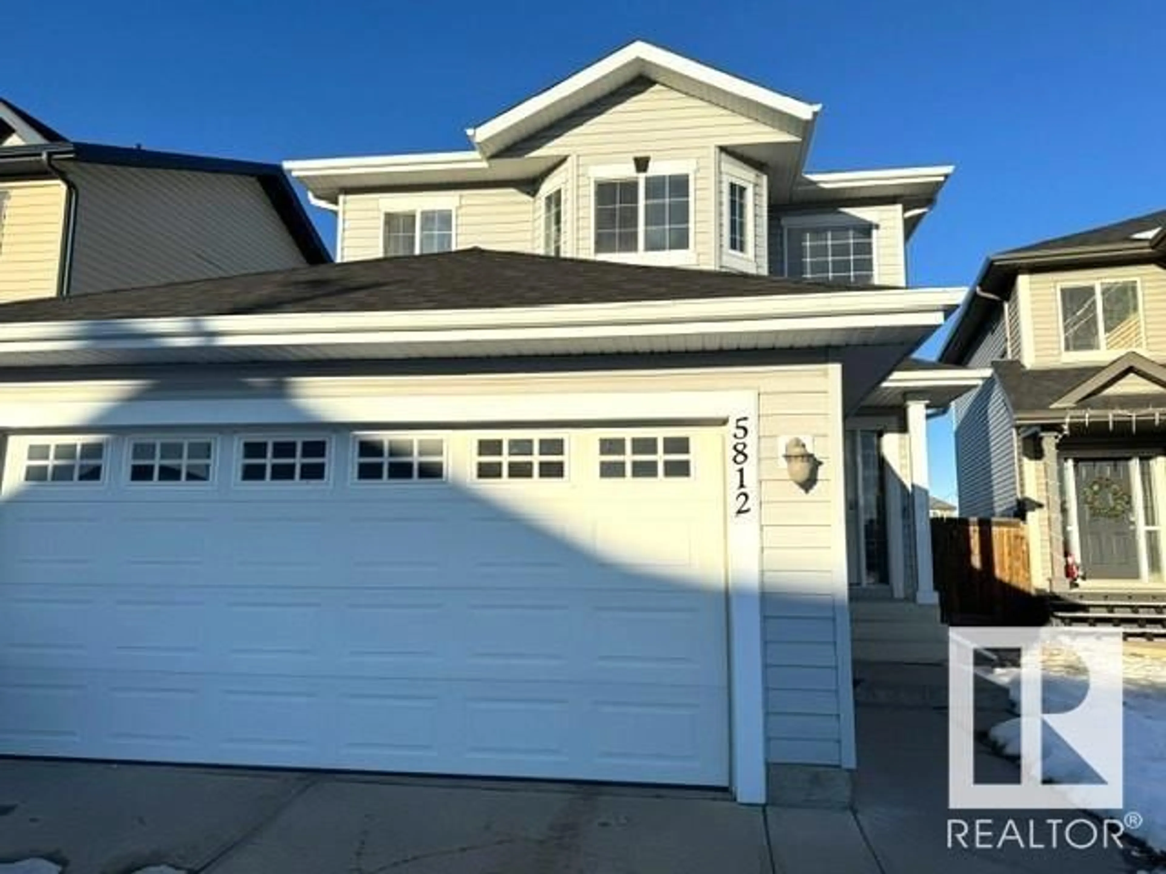 Home with vinyl exterior material, street for 5812 166 AV NW, Edmonton Alberta T5Y0B4