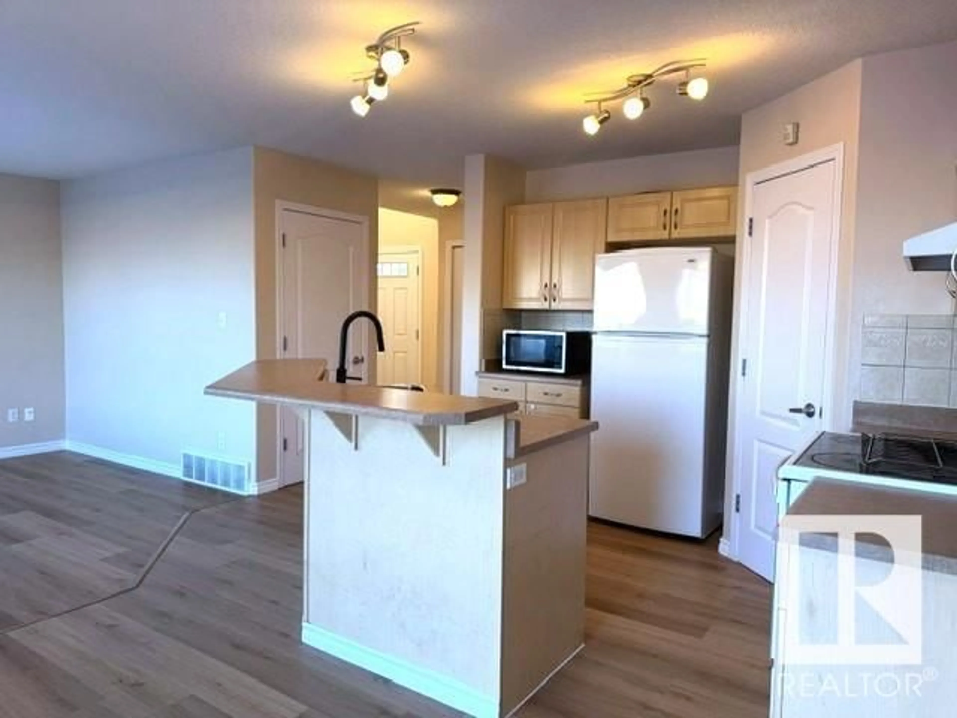 Open concept kitchen, wood/laminate floor for 5812 166 AV NW, Edmonton Alberta T5Y0B4