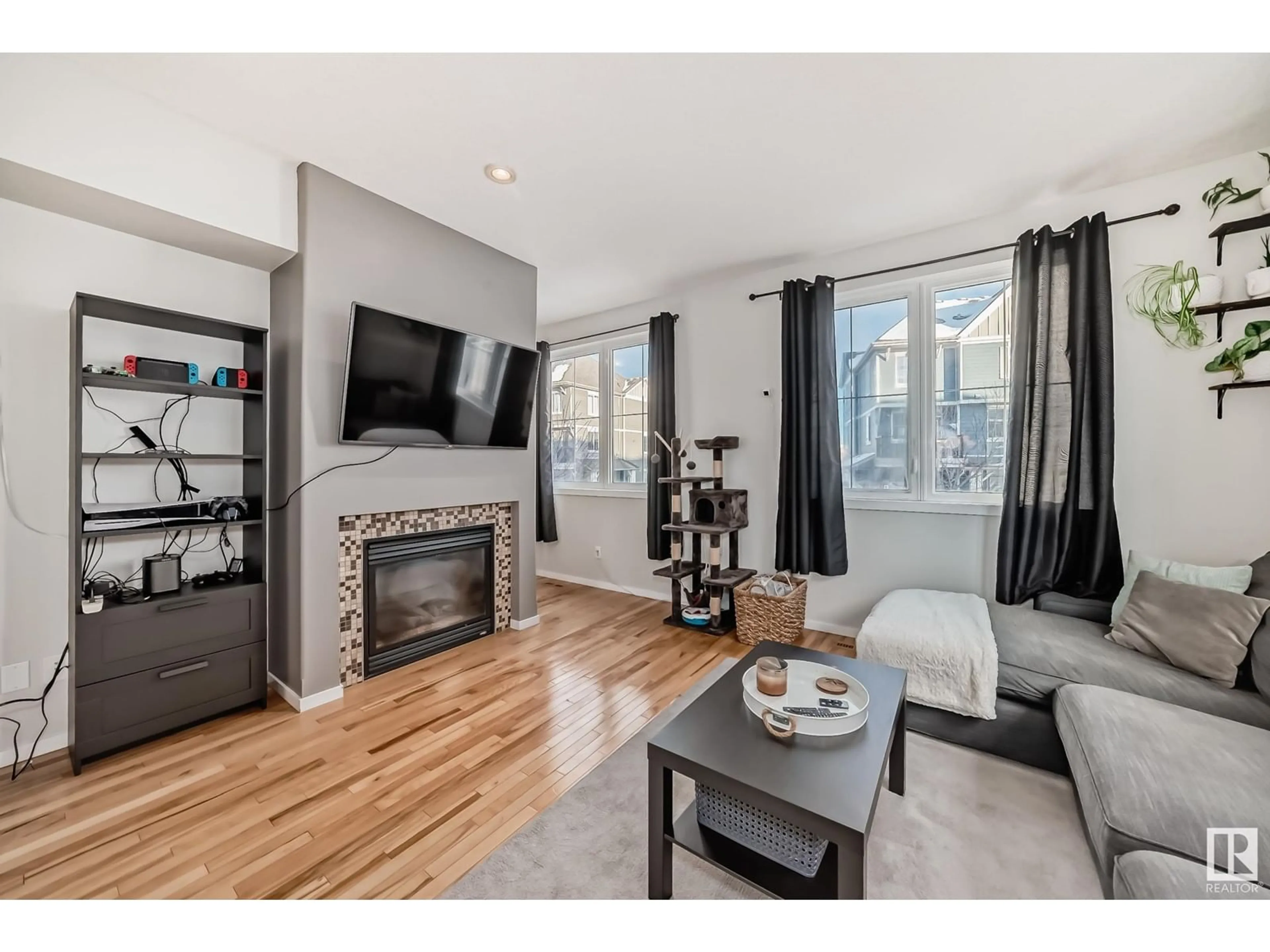 Living room with furniture, wood/laminate floor for #166 603 WATT BV SW, Edmonton Alberta T6X0P3