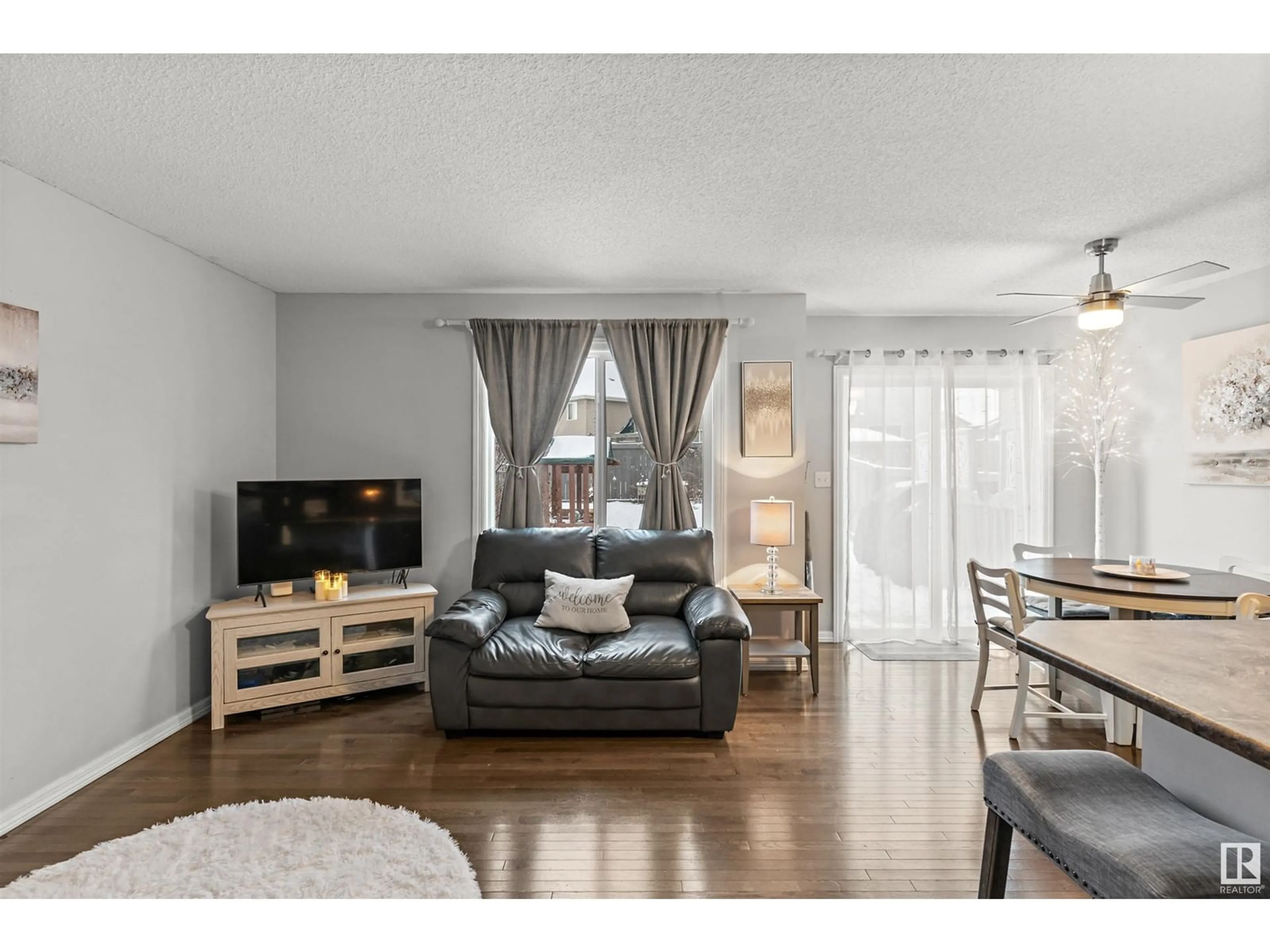 Living room with furniture, wood/laminate floor for 138 CALVERT WD, Fort Saskatchewan Alberta T8L0E6