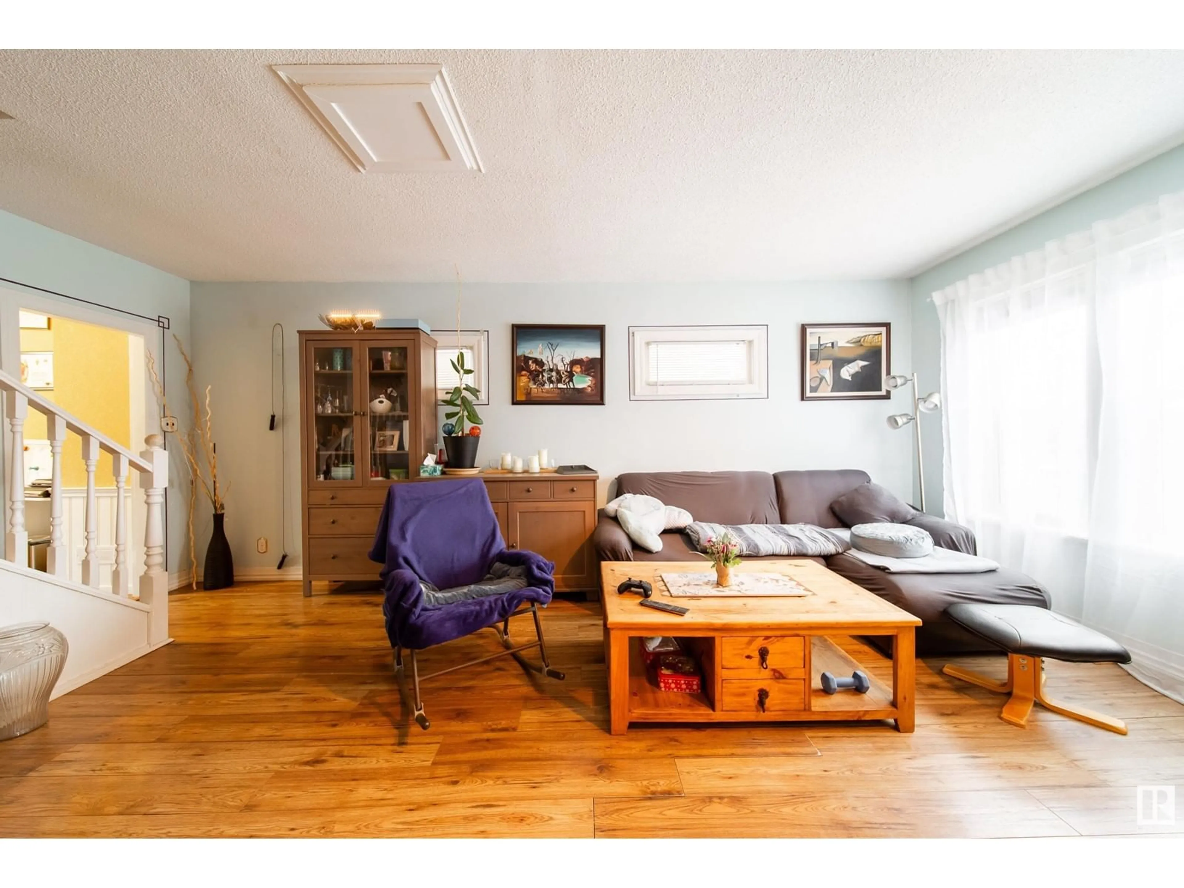 Living room with furniture, wood/laminate floor for 11519 95 ST NW, Edmonton Alberta T5G1L5