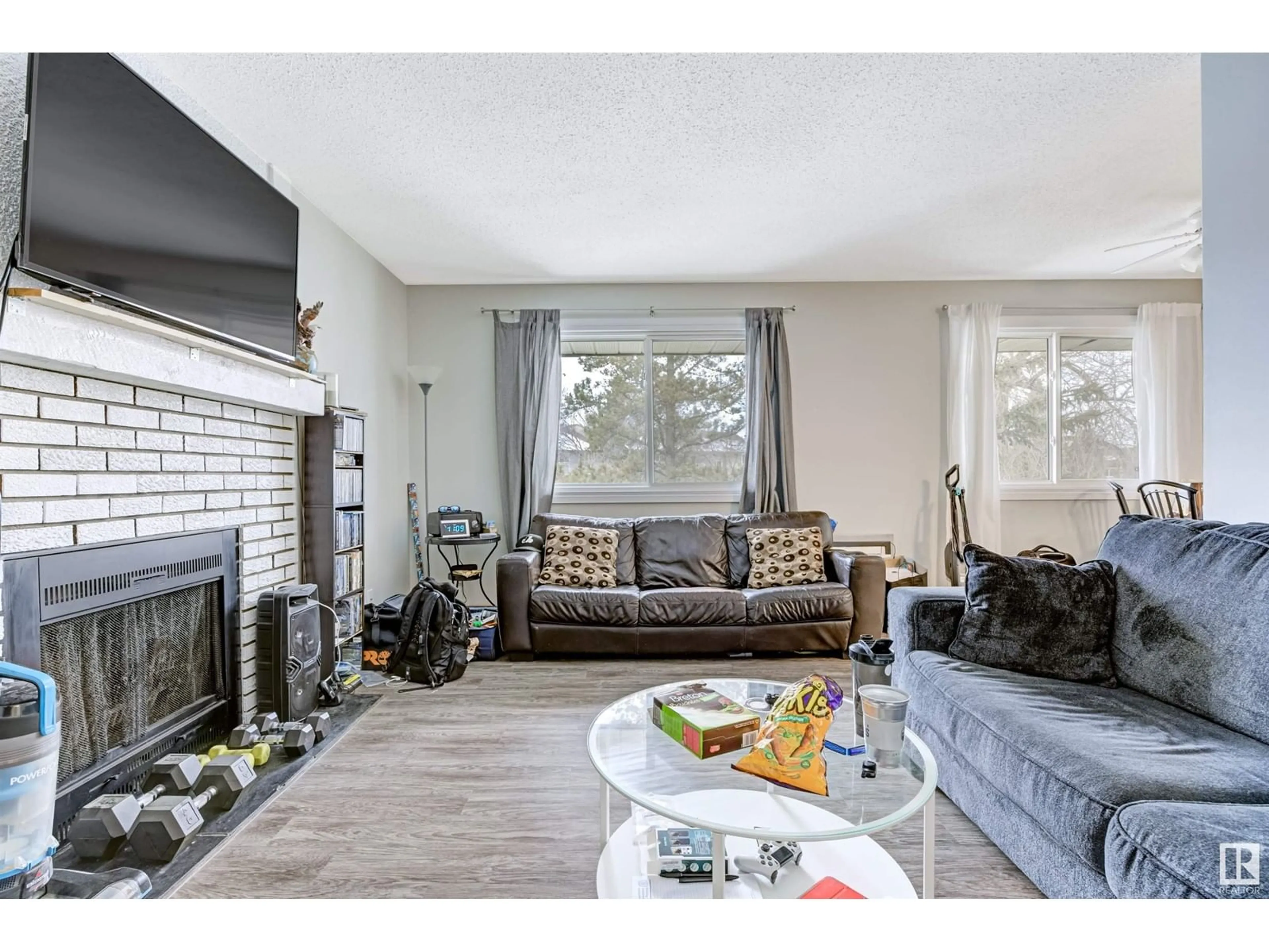 Living room with furniture, wood/laminate floor for #302 6204 180 ST NW, Edmonton Alberta T5T3J9