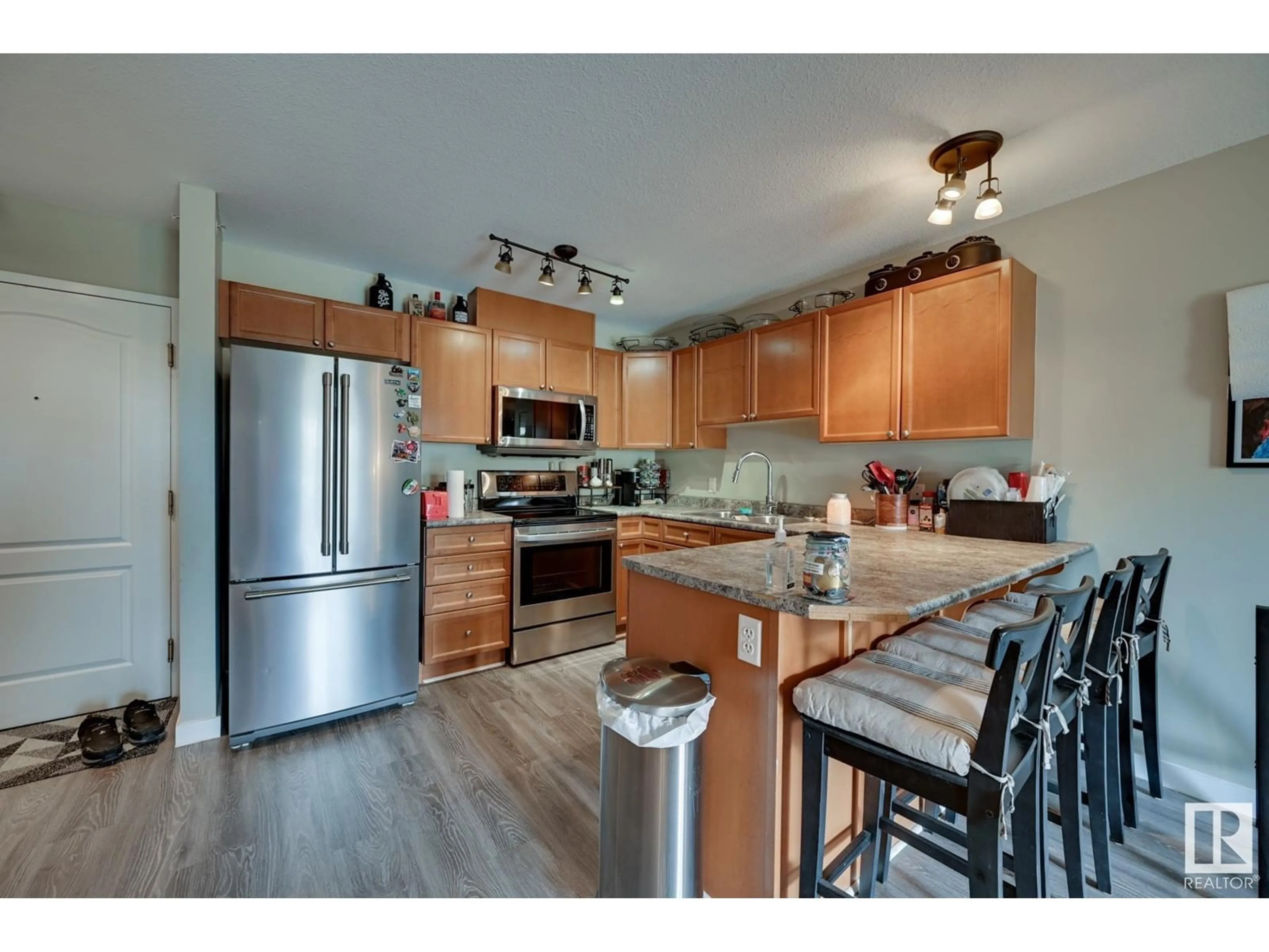 Open concept kitchen, wood/laminate floor for #412 4903 47 AV, Stony Plain Alberta T7Z1S3