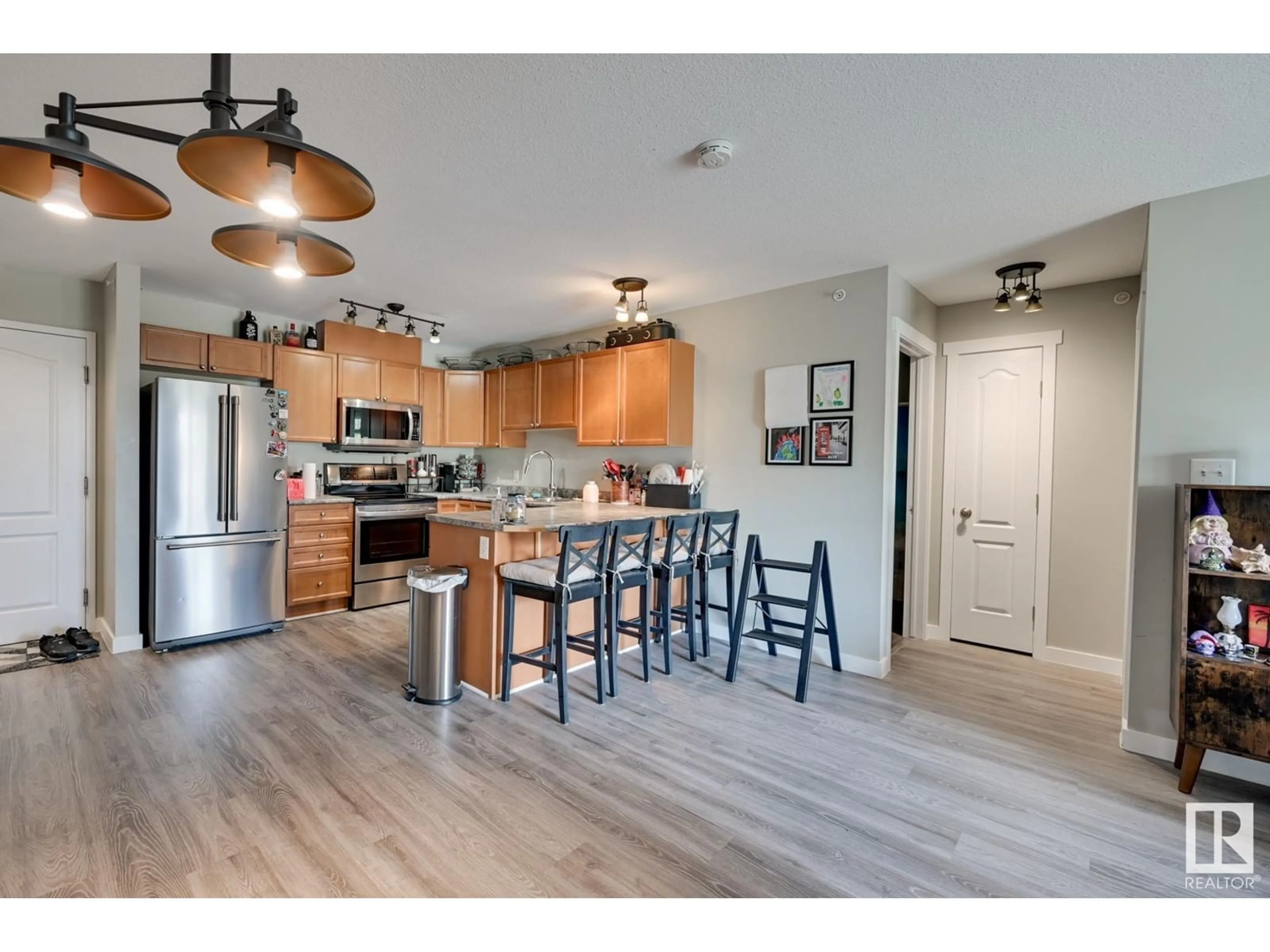 Open concept kitchen, wood/laminate floor for #412 4903 47 AV, Stony Plain Alberta T7Z1S3