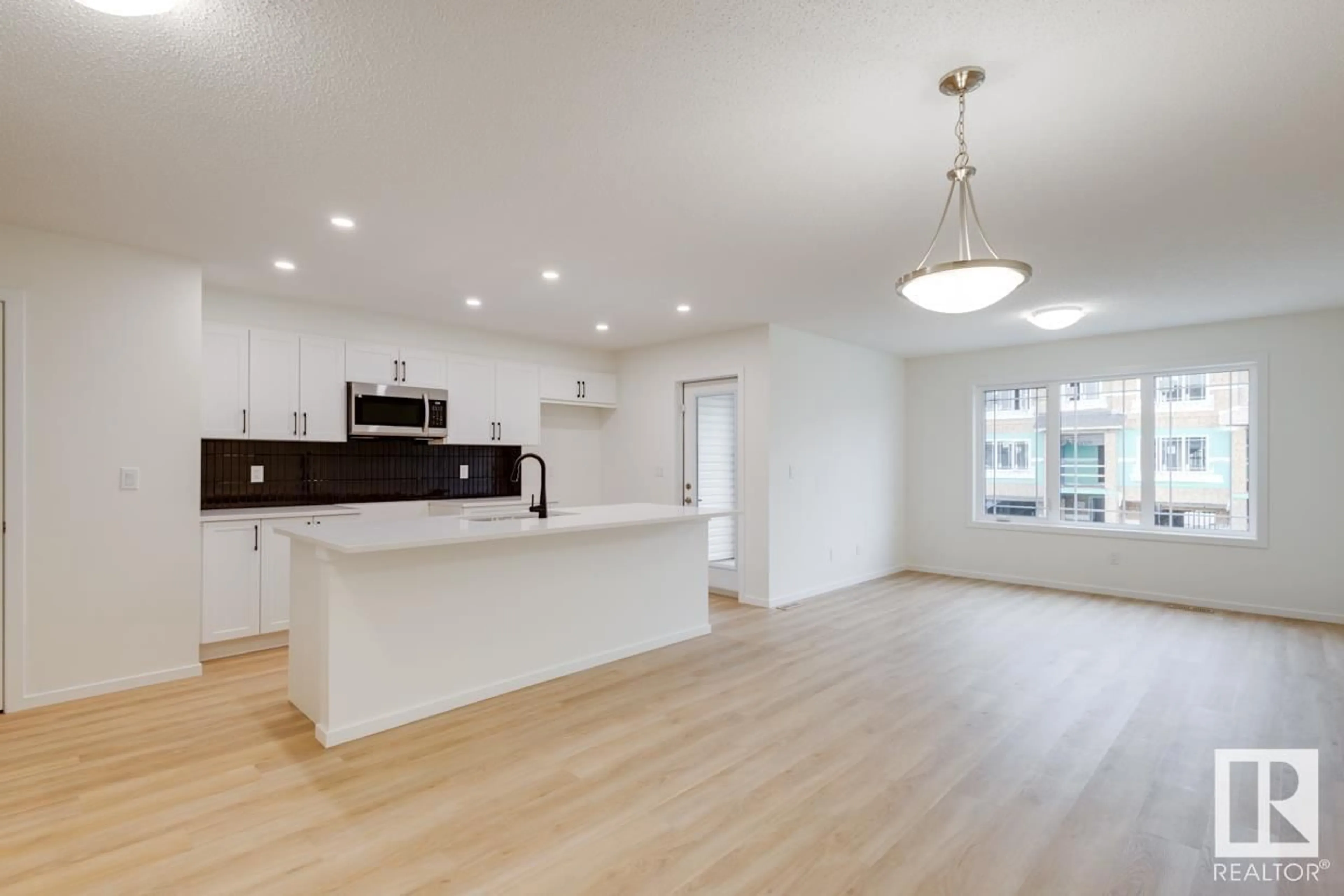 Open concept kitchen, wood/laminate floor for 20625 21A AV NW, Edmonton Alberta T6M1N3