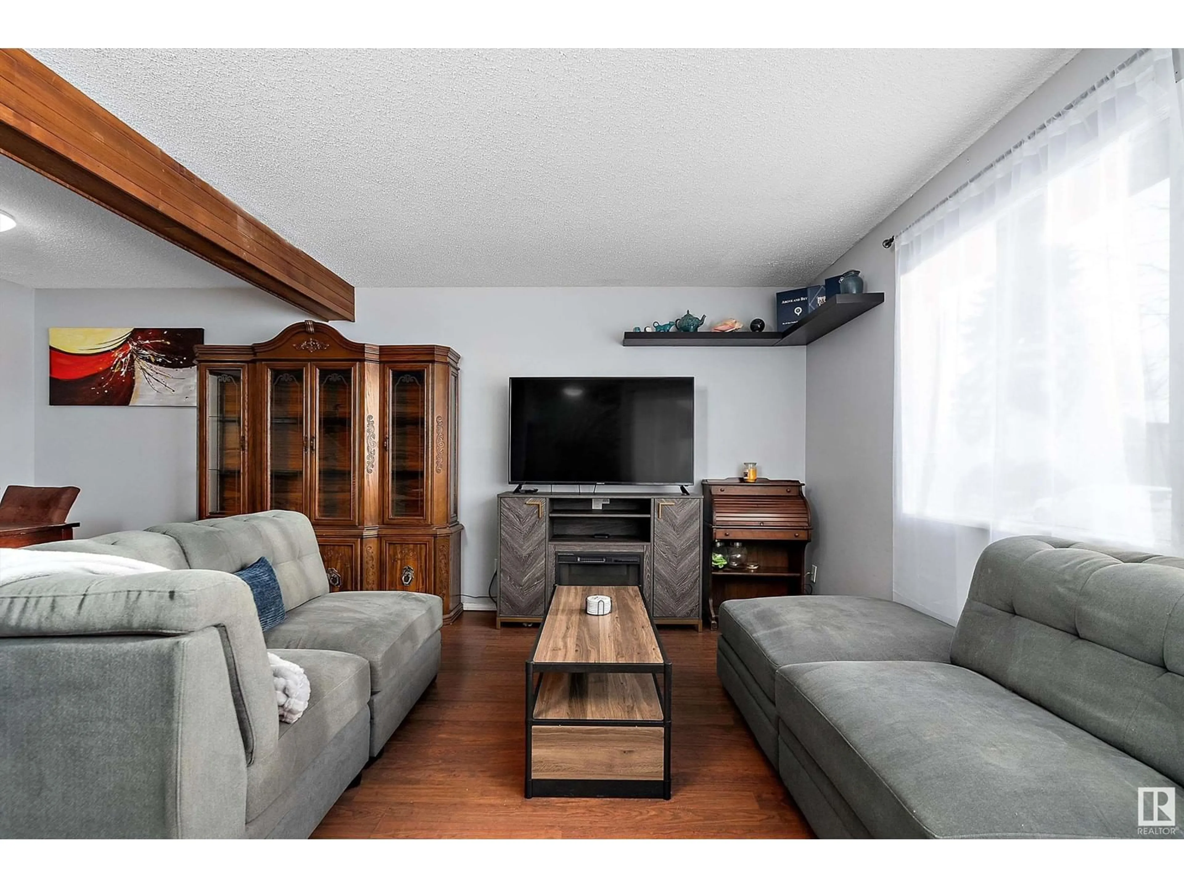 Living room with furniture, wood/laminate floor for 3622 42 AV NW, Edmonton Alberta T6L5C8