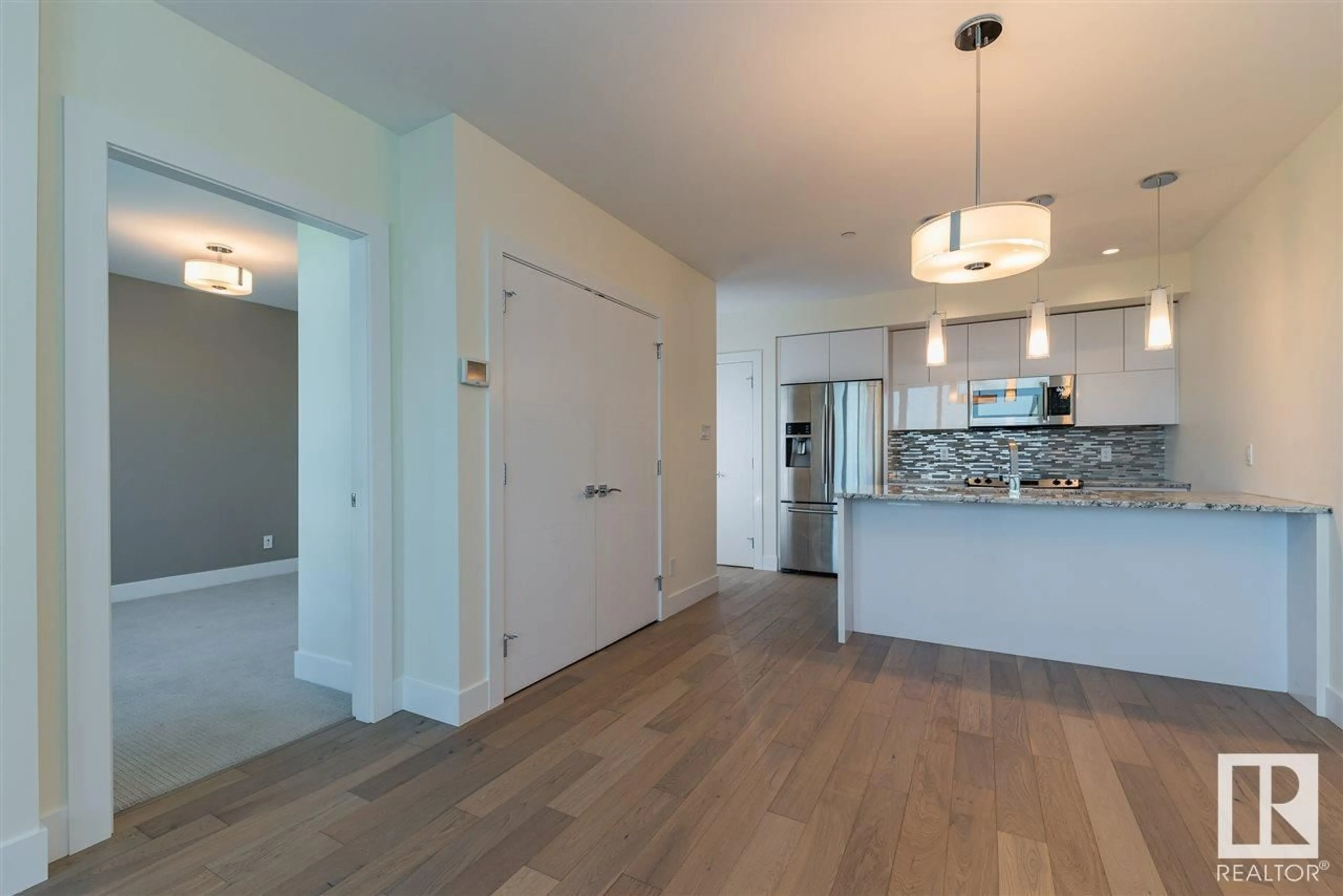 Open concept kitchen, wood/laminate floor for #401 11969 JASPER AV NW, Edmonton Alberta T5K0P1