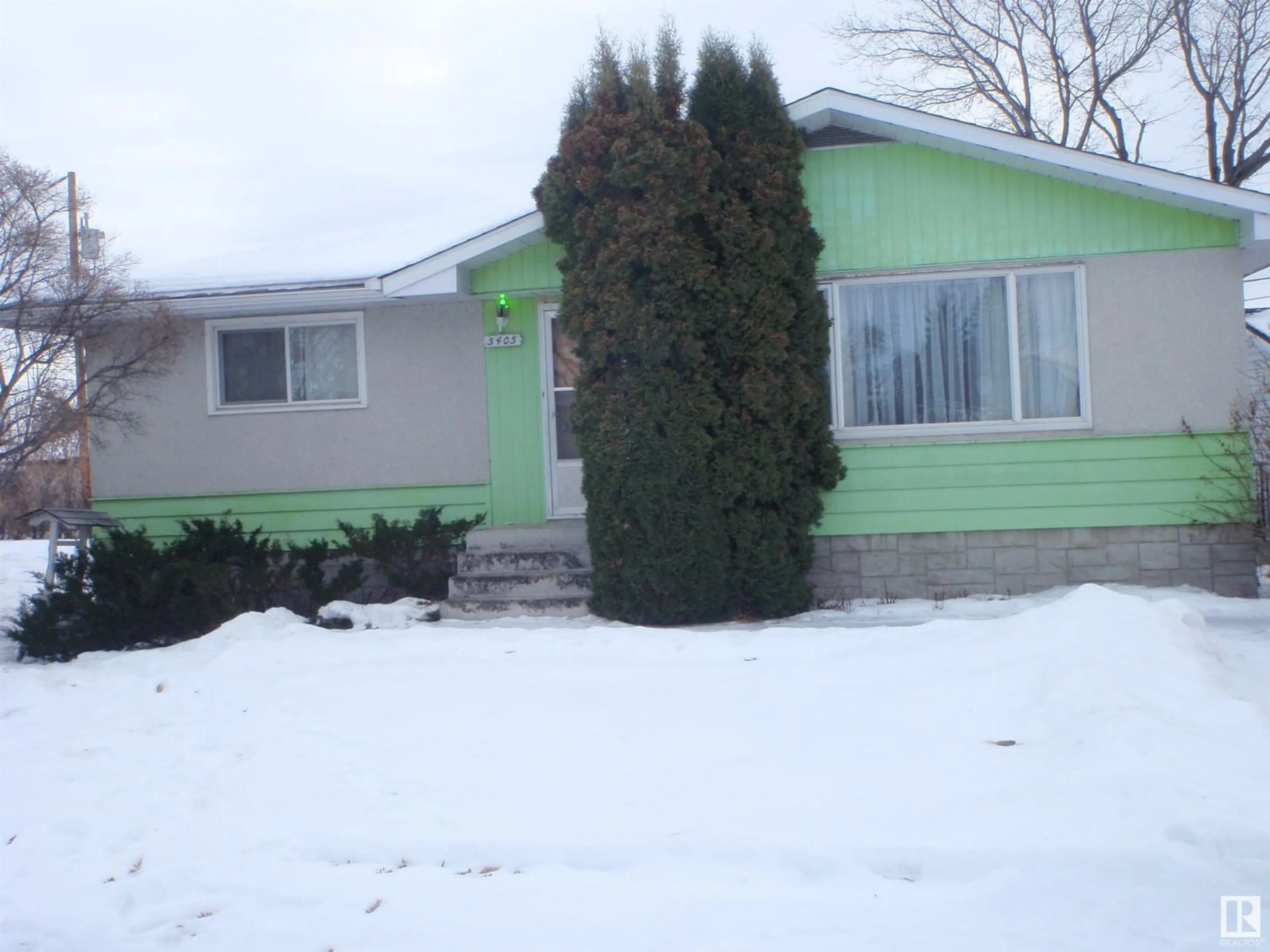 Home with vinyl exterior material, street for 5405 54 AV, Barrhead Alberta T7N1C4