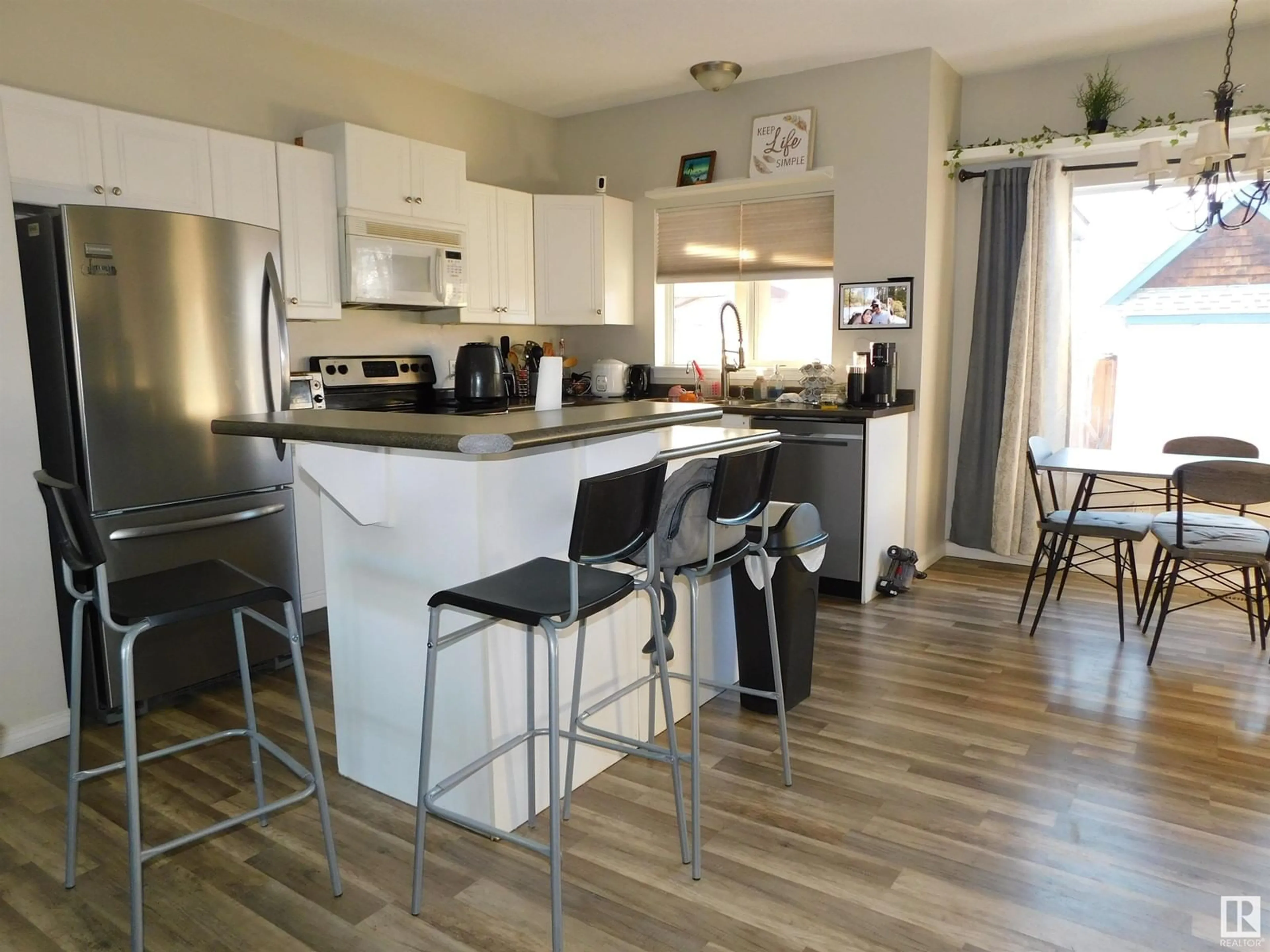 Open concept kitchen, wood/laminate floor for 15012 136 ST NW, Edmonton Alberta T6V1N2