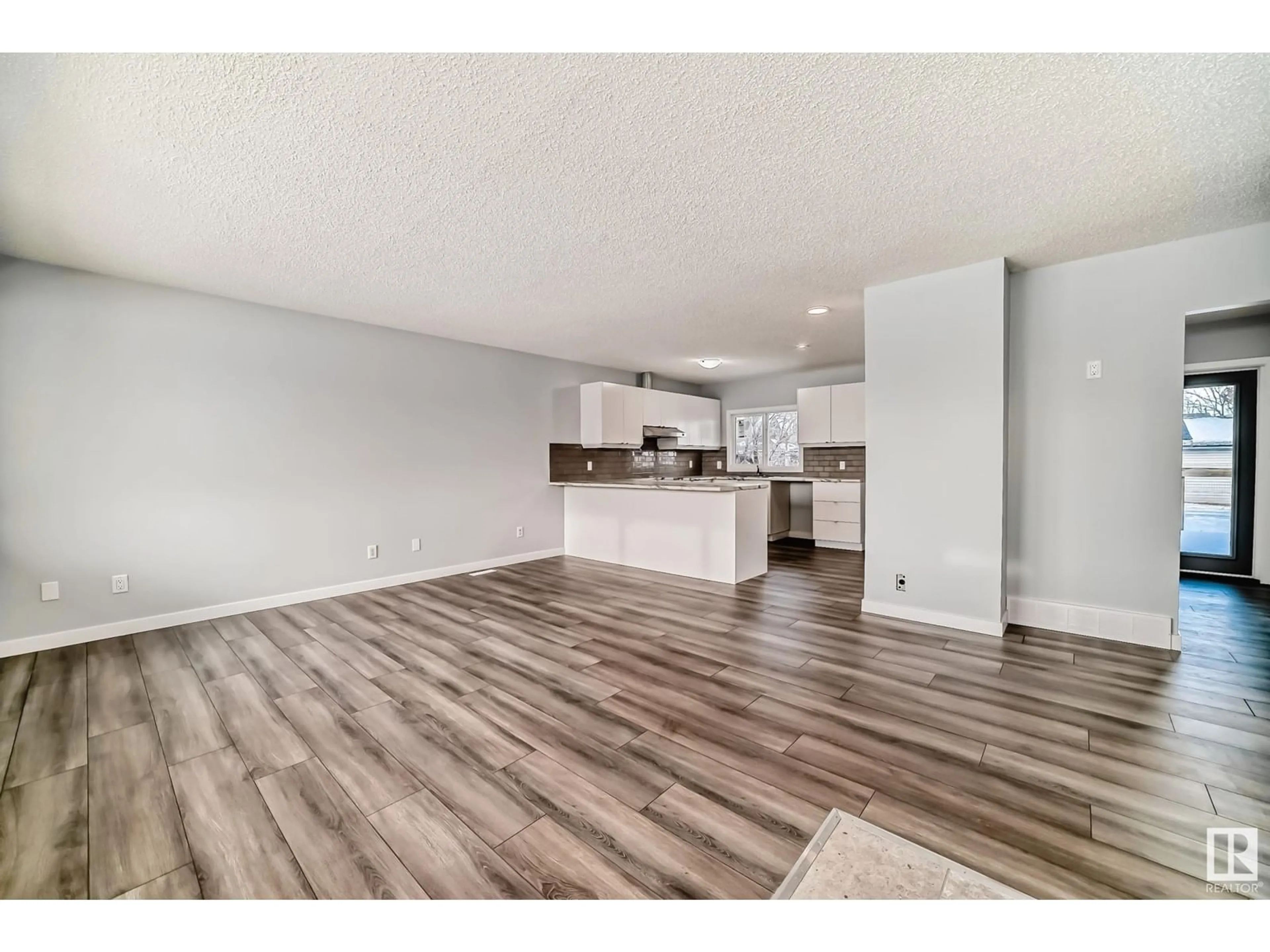 Open concept kitchen, wood/laminate floor for 15732 107A AV NW, Edmonton Alberta T5P0Z1