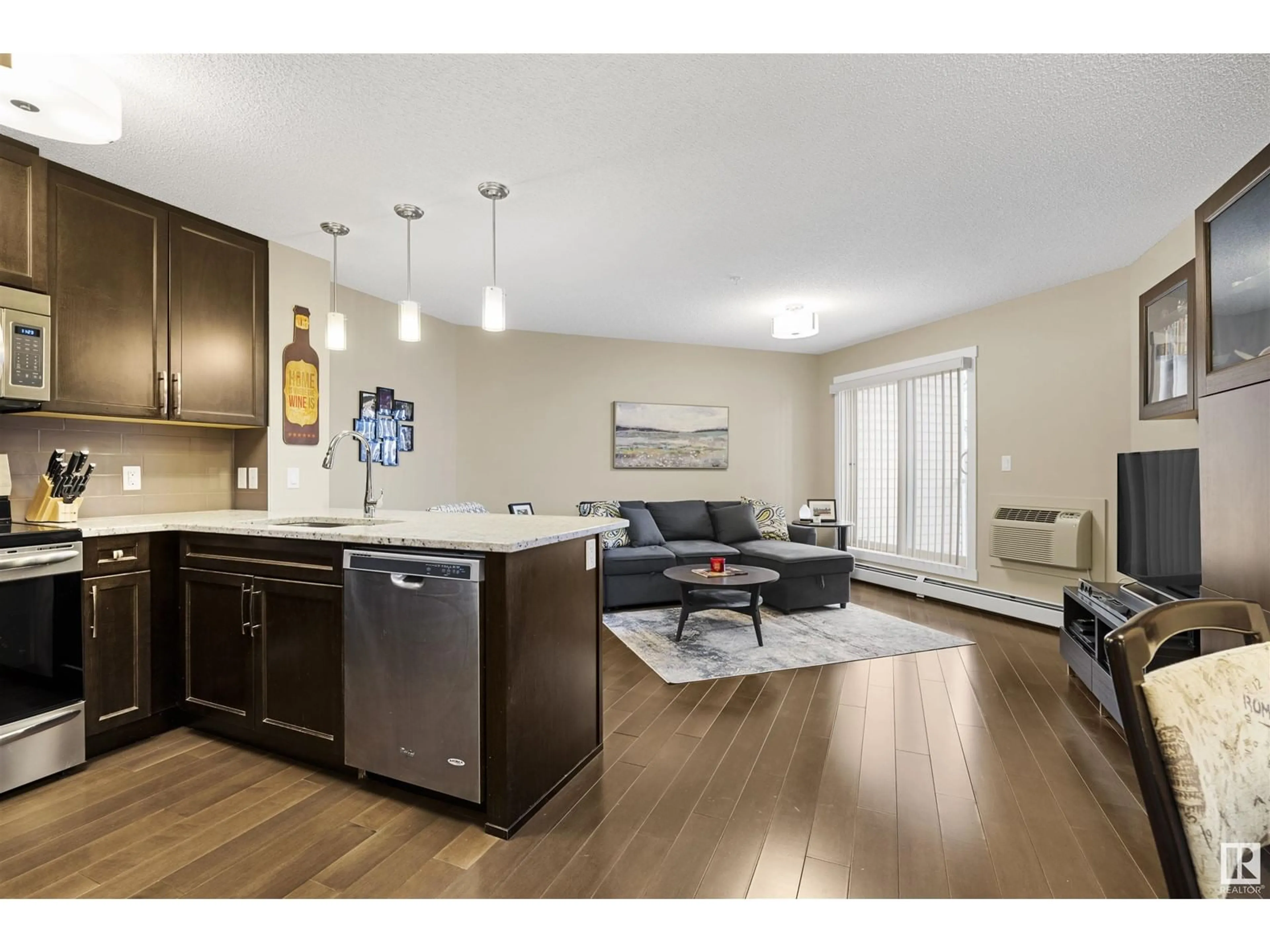 Open concept kitchen, wood/laminate floor for #214 2207 44 AV NW, Edmonton Alberta T6T0T2