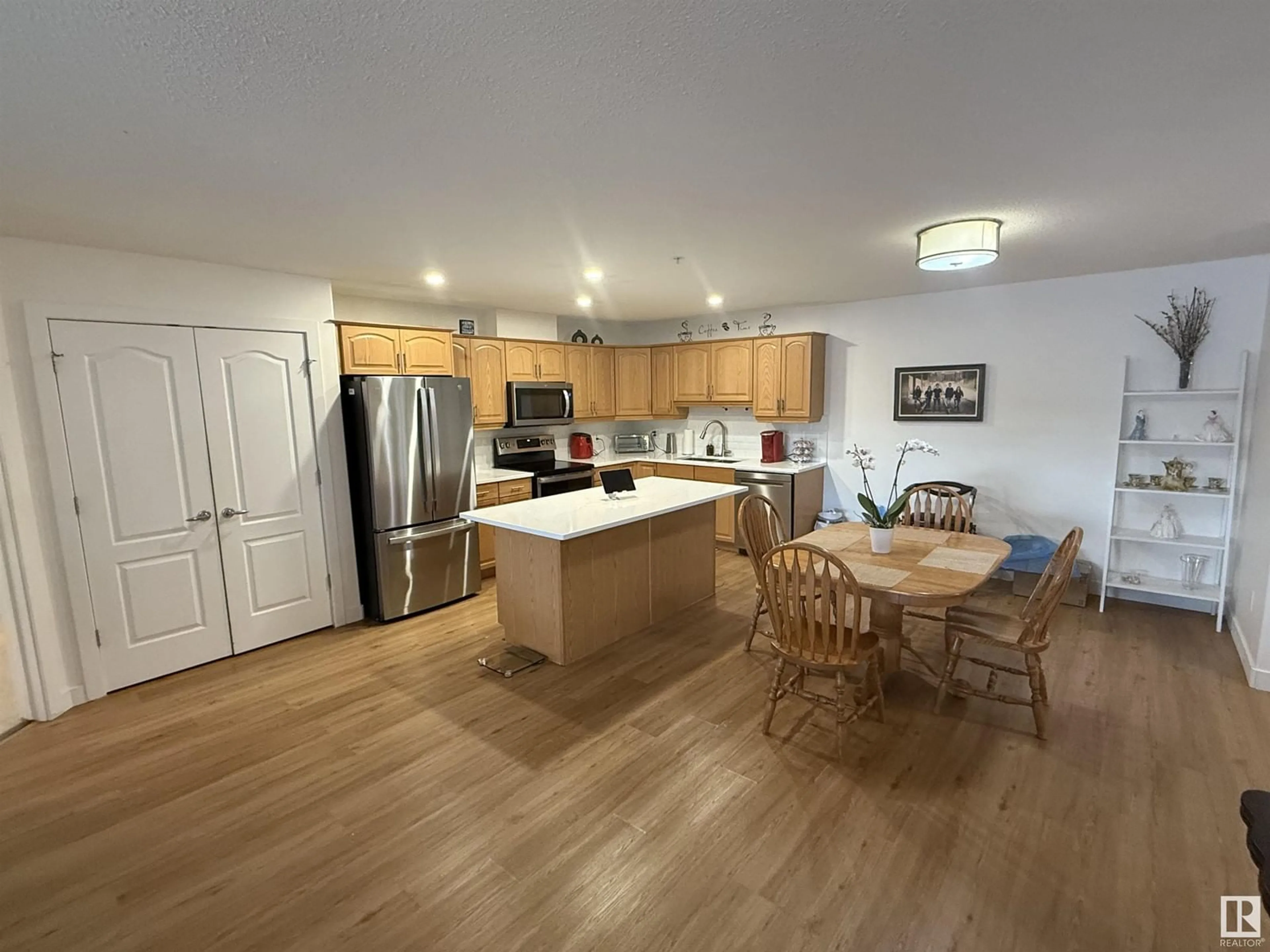 Open concept kitchen, wood/laminate floor for #320 278 SUDER GREENS DR NW, Edmonton Alberta T5T6V6