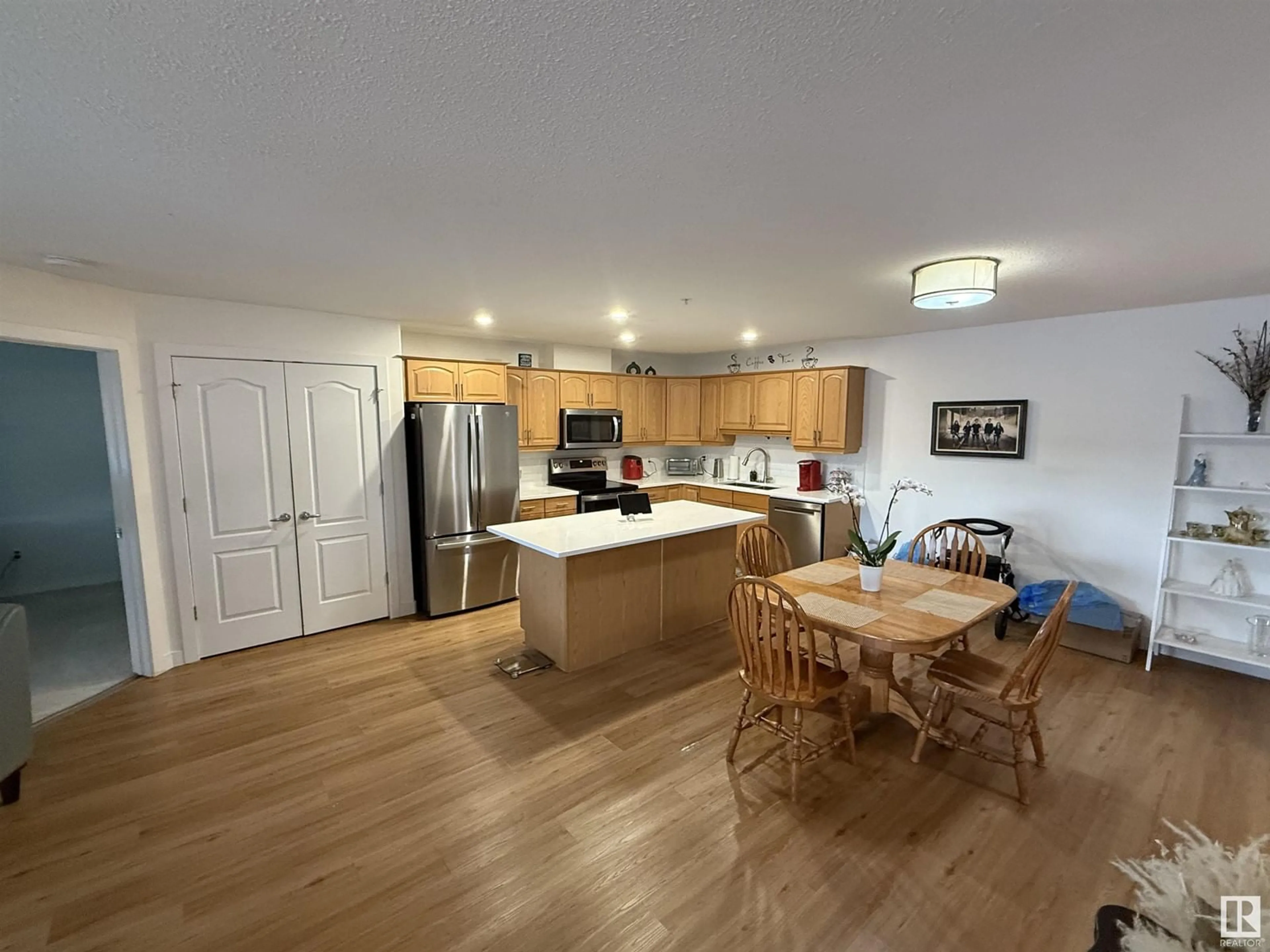 Open concept kitchen, wood/laminate floor for #320 278 SUDER GREENS DR NW, Edmonton Alberta T5T6V6