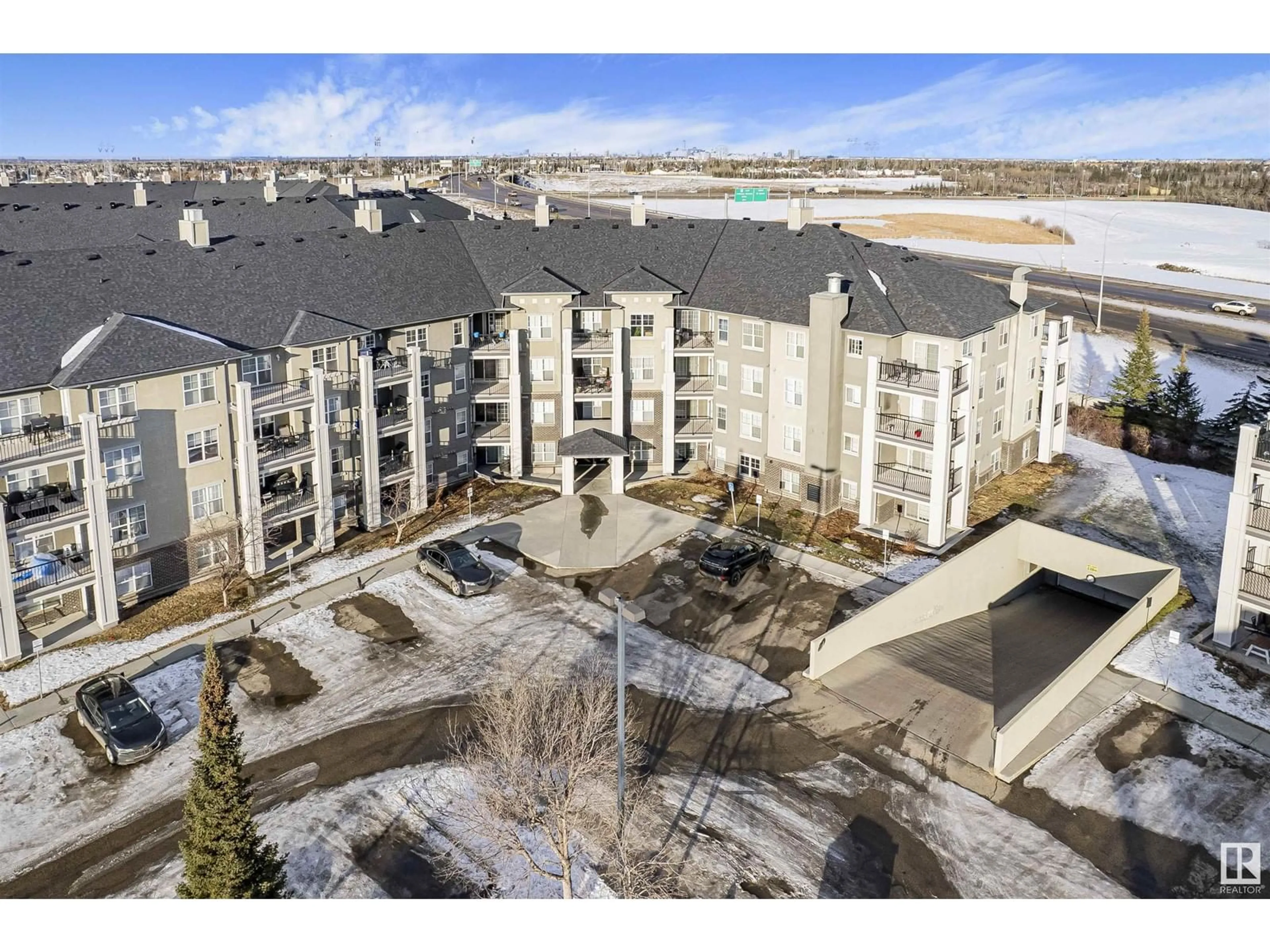 A pic from outside/outdoor area/front of a property/back of a property/a pic from drone, mountain view for #210 622 MCALLISTER LO SW, Edmonton Alberta T6W1N2